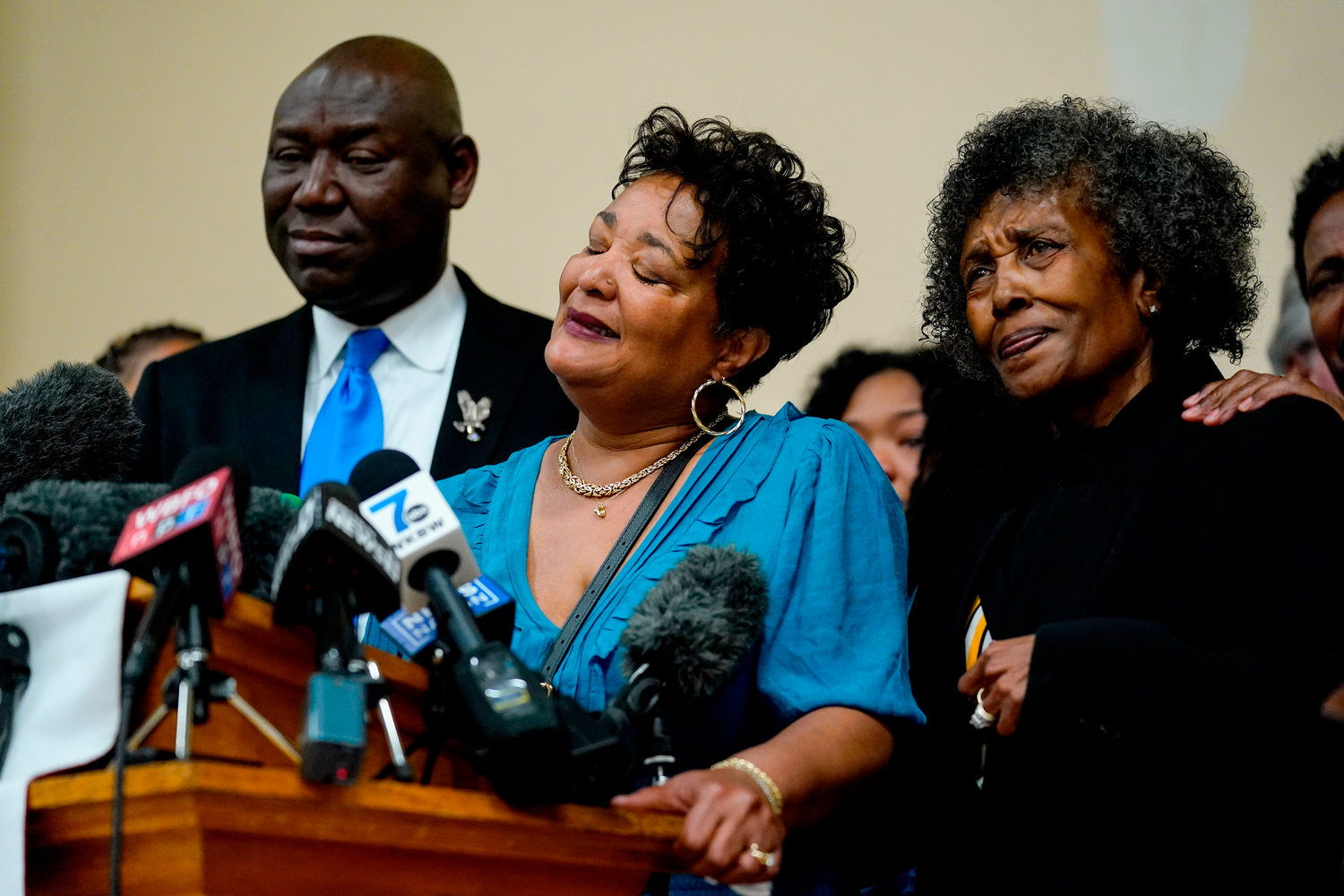 The daughters of Ruth Whitfield, a victim of shooting at a supermarket, Angela Crawley, center, and Robin Harris, accompanied by attorney Benjamin Crump, speak with members of the media during a news conference in Buffalo, N.Y., Monday, May 16, 2022. (AP Photo/Matt Rourke)