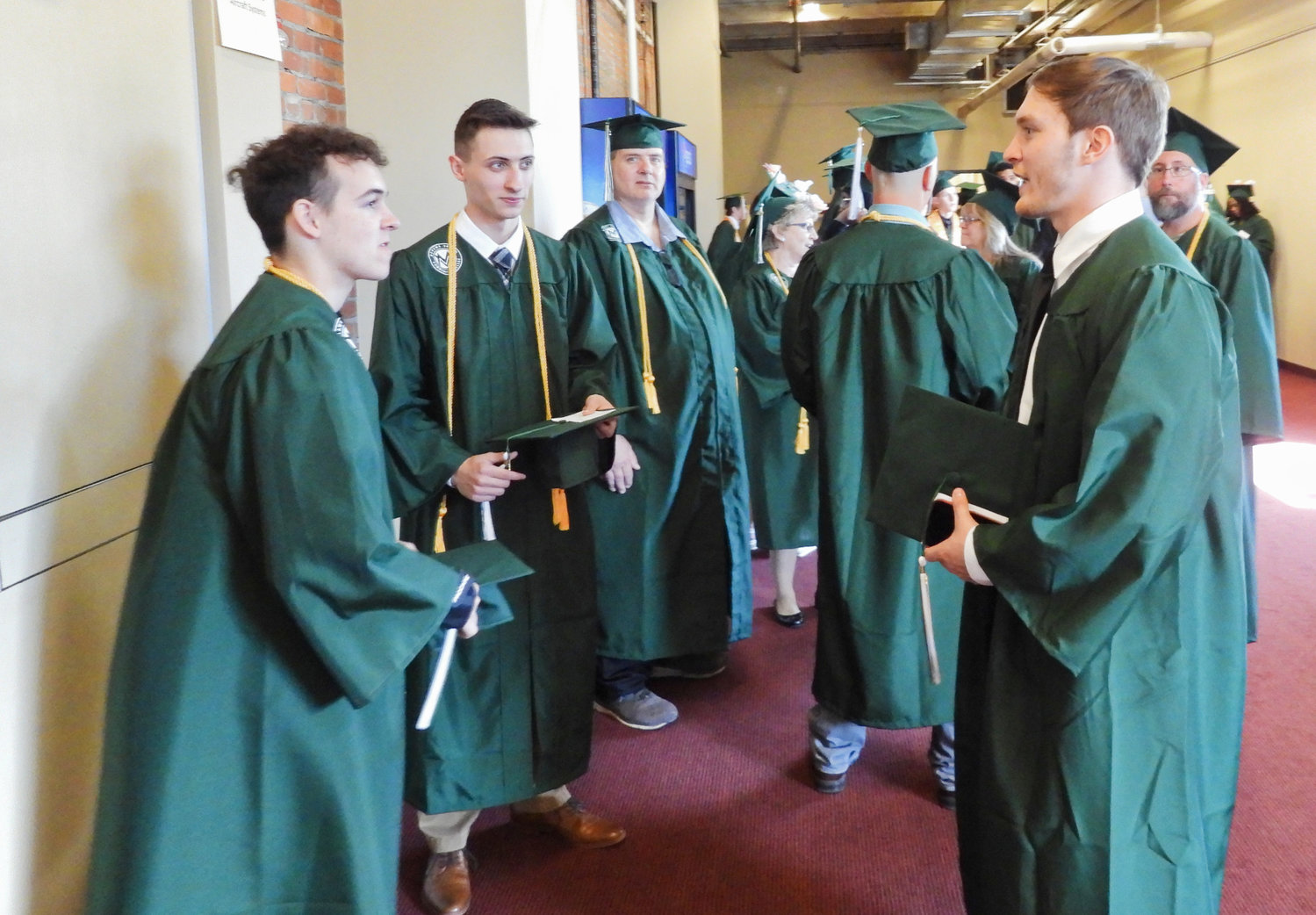 Mohawk Valley Community College graduates talk and celebrate their eminent graduation at the Stanley Theater on Friday, May 13.