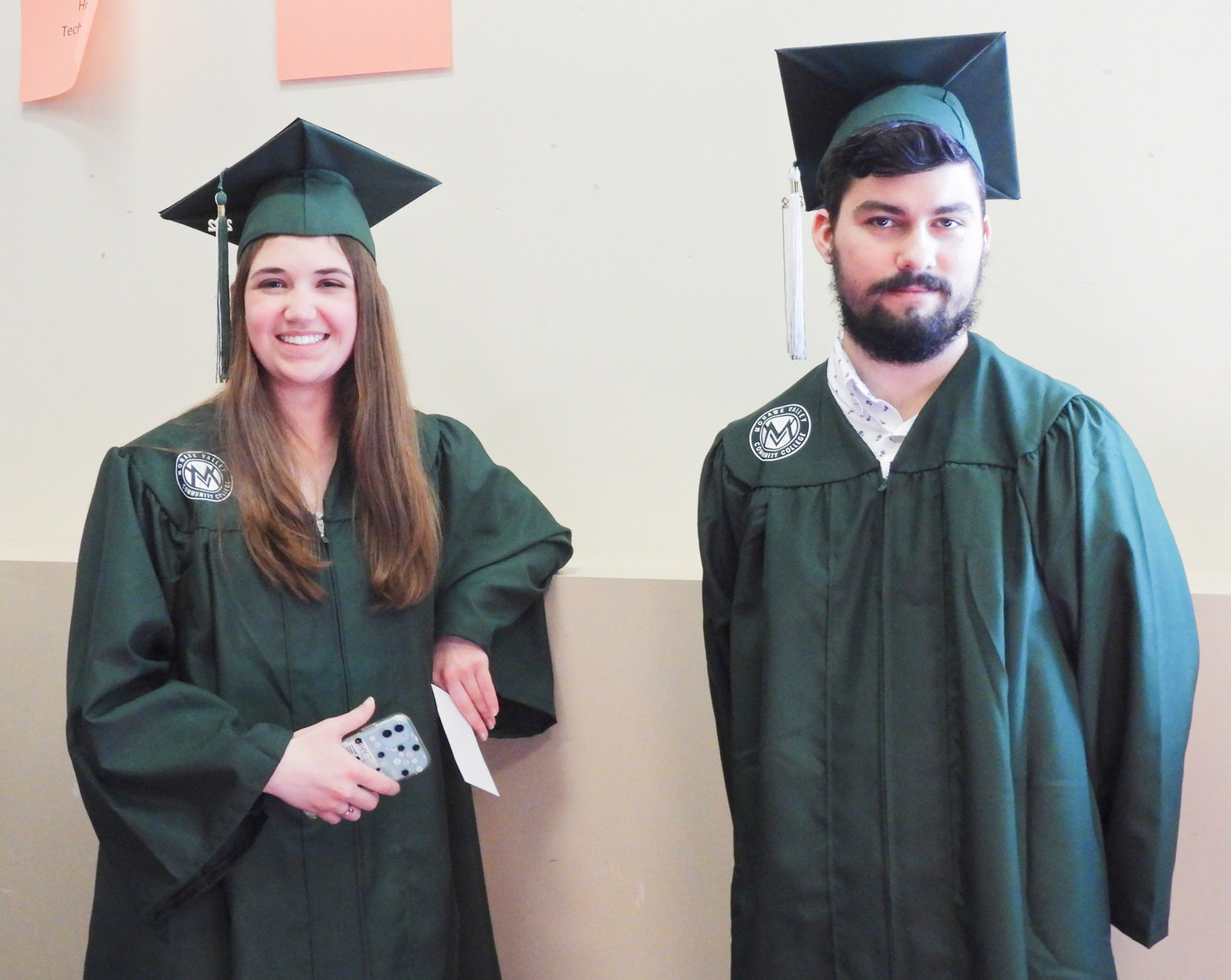 A pair of Mohawk Valley Community College graduates eagerly await their time to receive their diploma and start the next chapter of their lives.