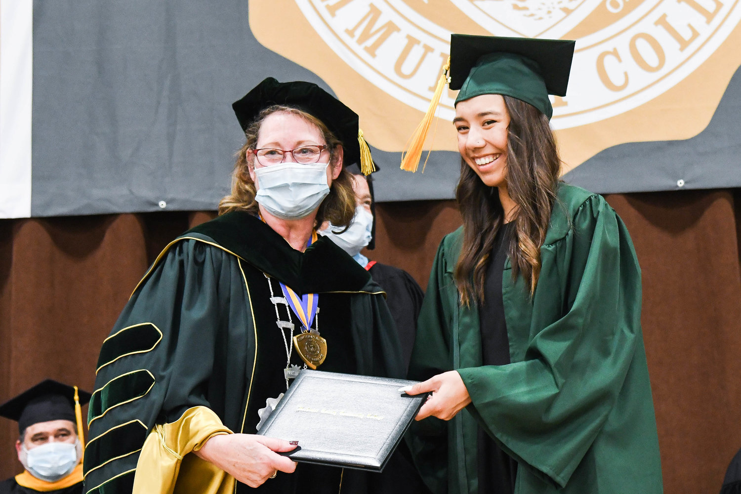 Makenna Hill receives her certificate of graduation as Herkimer County Community College conducted its 54th commencement ceremony on Friday.