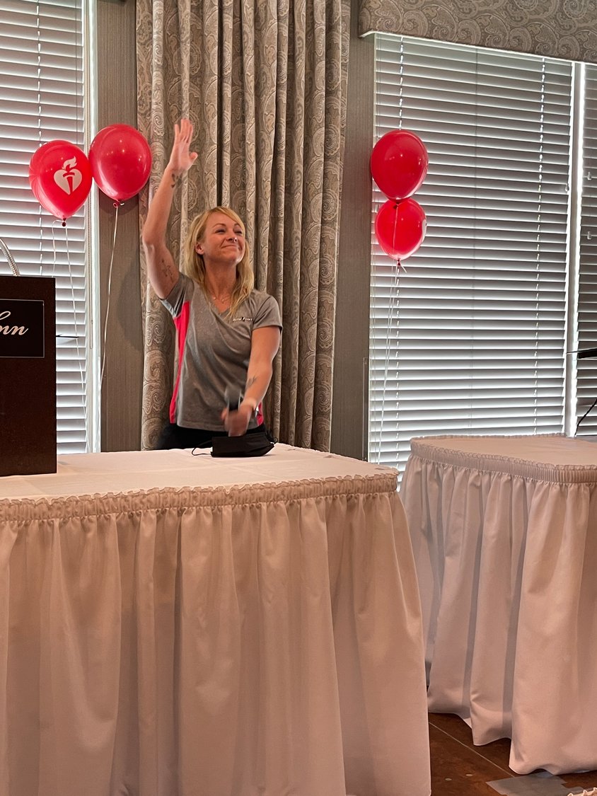 Hollie Raux of Retro Fitness gets the crowd up and moving at this year’s Go Red for Women Luncheon on Wednesday at Hart’s Hill Inn in Whitesboro.