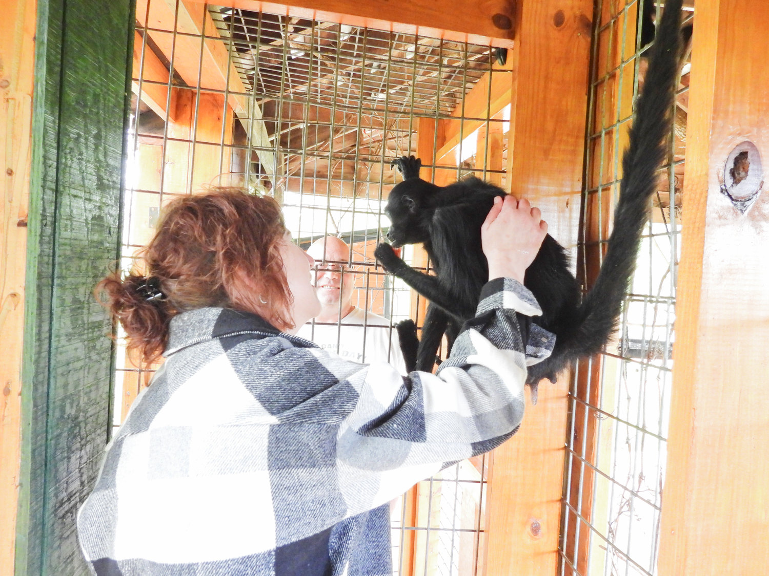 Eclectic Chic owner Valerie Pollack spends time with Gummy, the 60-year-old spider monkey at Fort Rickey Discovery Zoo