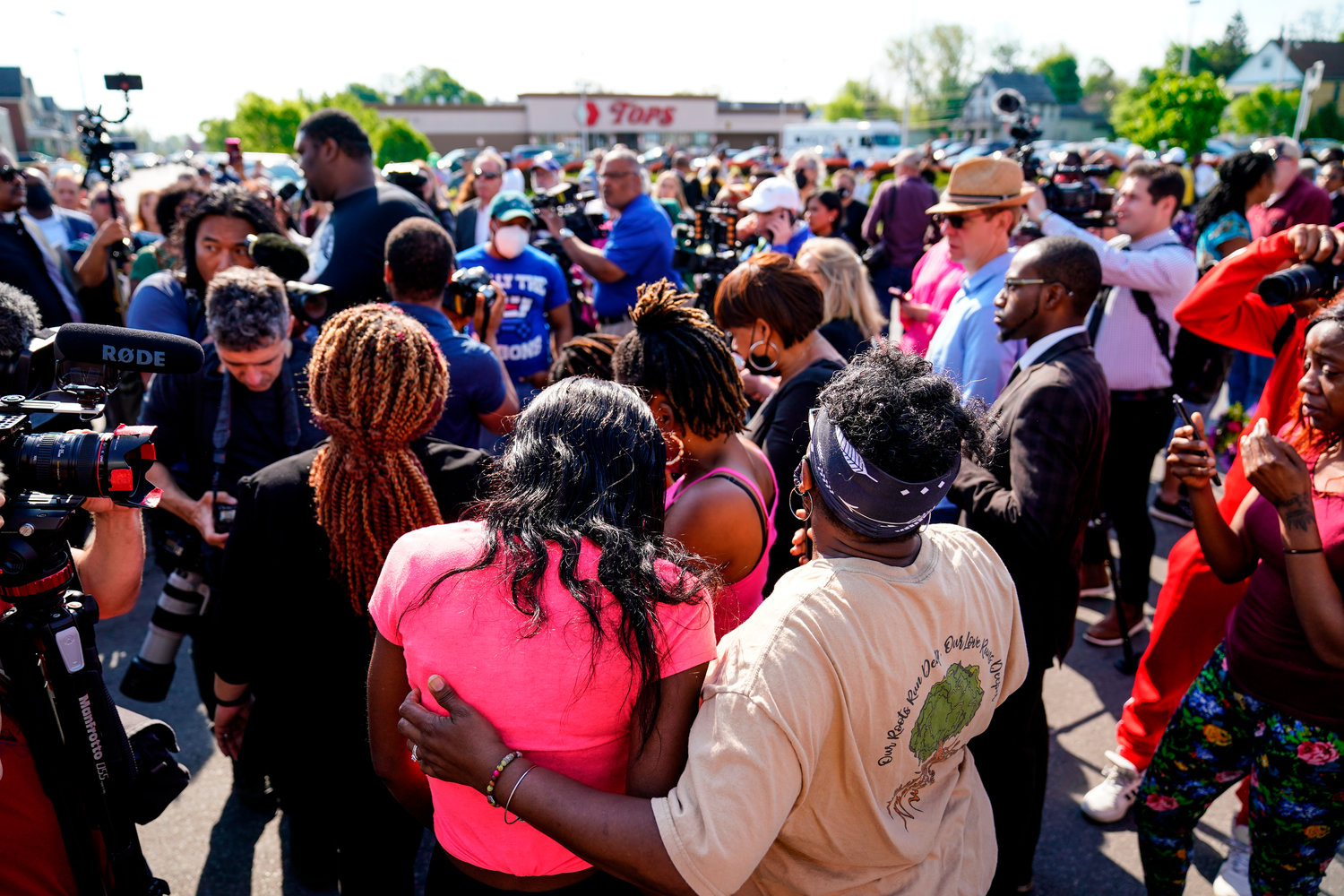 People gather outside the scene of a shooting at a supermarket, in Buffalo, N.Y. The NAACP, the nation’s oldest civil rights organization, said it will propose a sweeping plan meant to protect Black Americans from white supremacist violence, in response to a hate-fueled massacre that killed 10 Black people in Buffalo.