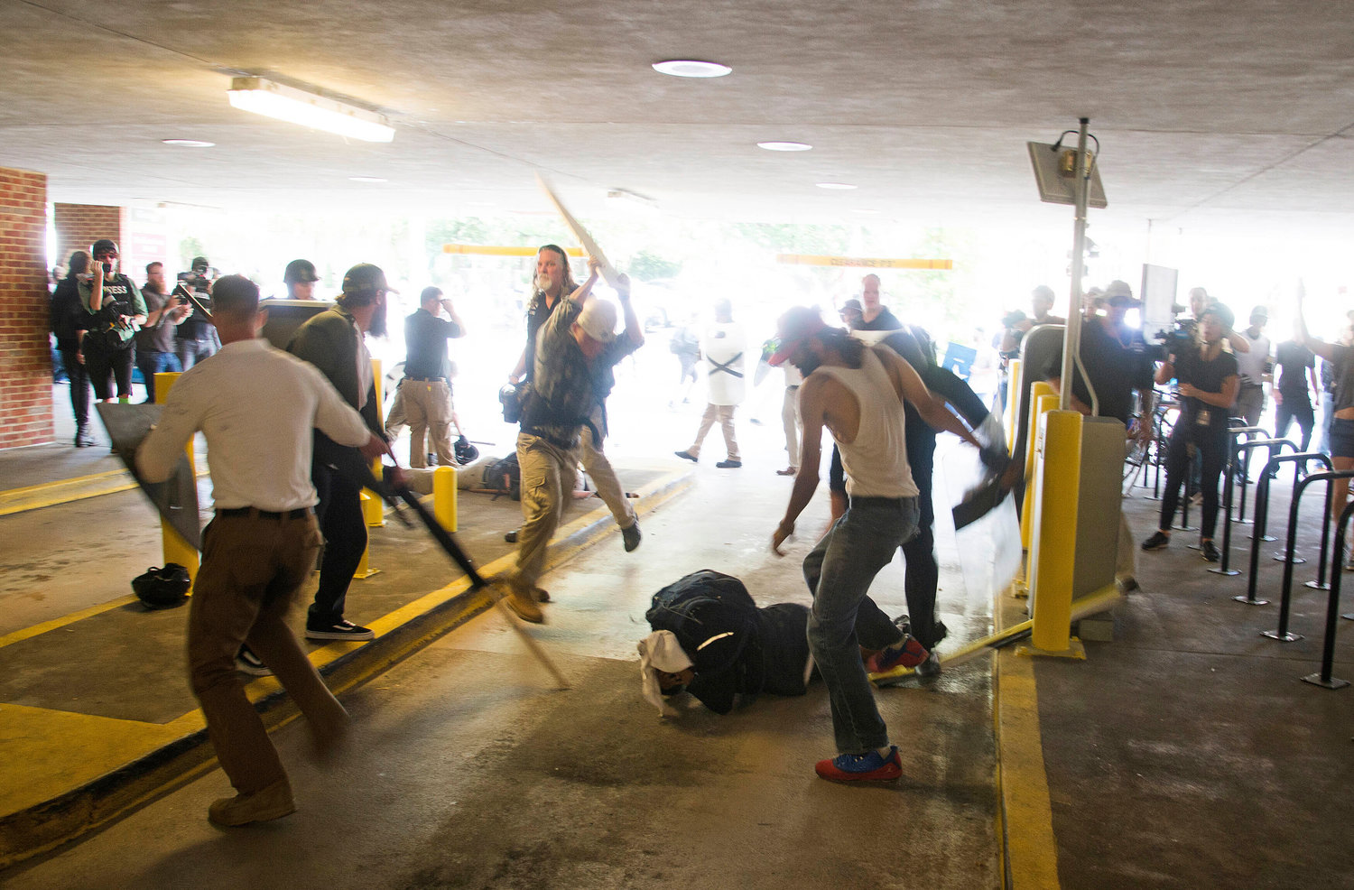FILE - DeAndre Harris, bottom is assaulted in a parking garage beside the Charlottesville police station after a white nationalist rally was dispersed by police, on Aug. 12, 2017 in Charlottesville, Va. Harris, an African-American man who was severely beaten the day of a violent white nationalist rally, and then charged with misdemeanor assault in the same incident. The NAACP, the nation's oldest civil rights organization said it will propose a sweeping plan meant to protect Black Americans from white supremacist violence, in response to a hate-fueled massacre that killed 10 Black people in Buffalo, New York last weekend. (Zach D. Roberts via AP, File)