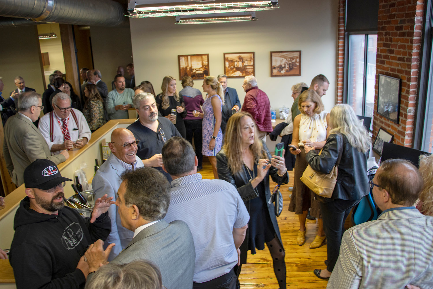 Guests at Sentinel Media Co.'s ribbon cutting celebration at their new Utica, location at 421 Broad St.