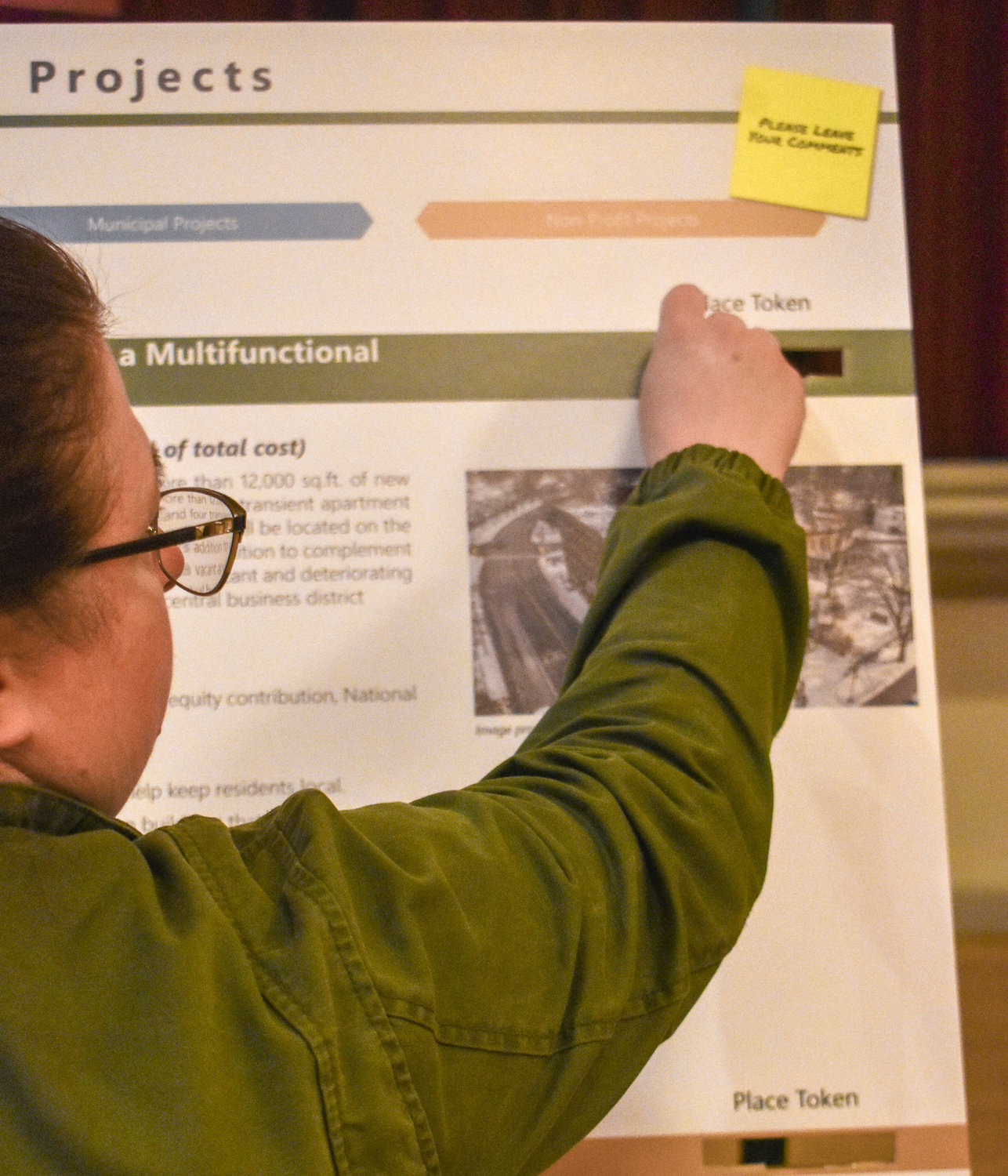 Guests were each given 10 tokens they could use to vote for their favorite DRI project proposals. As seen here, a guest drops one of their tokens into a project's slot.