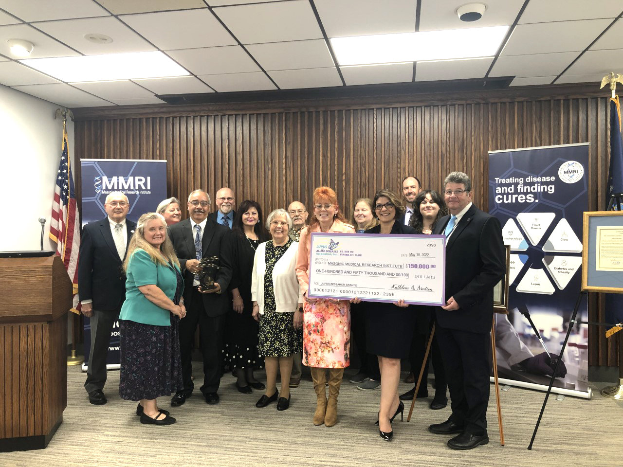 Officials with the Lupus and Allied Diseases Association, Inc. (LADA), present a check for $150,000 to the Masonic Medical Research Institute during an event Thursday. The organizations have teamed up to observe May as Lupus Awareness Month, and highlight their lupus research program.