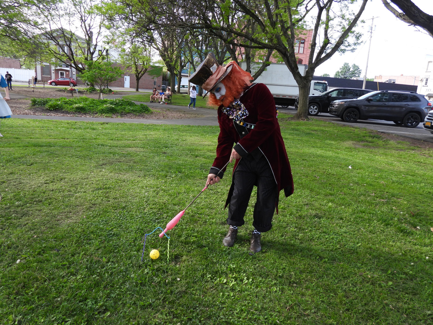 The Mad Hatter takes a swing at flamingo croquet, recreating a scene from "Alice in Wonderland" as part of the Oneida Parks and Recreation Department's "Through the Looking Glass" event, with members of the Bogardus Performing Art Center take the role of beloved characters.
