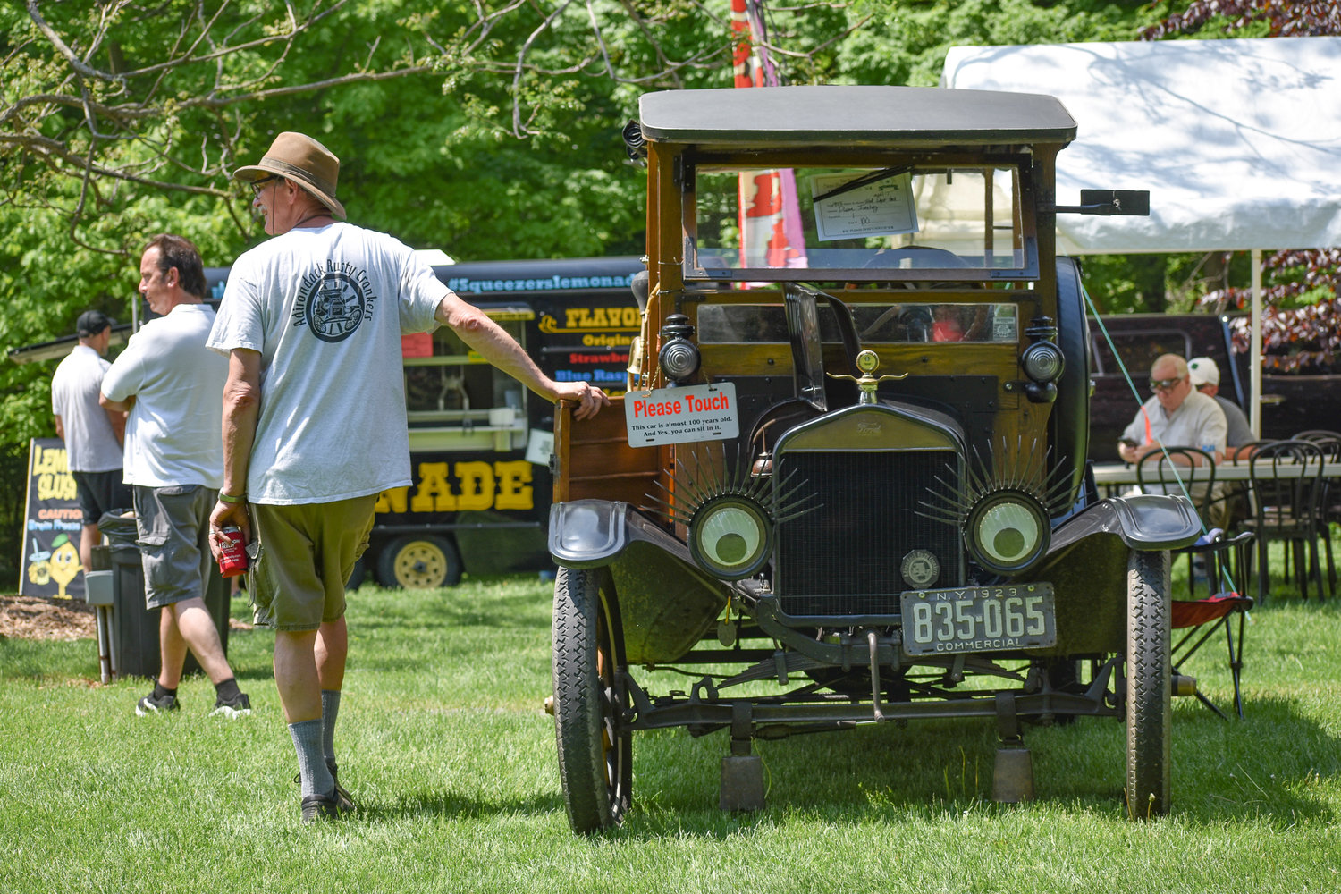 Visitors and participants at a classic car show at the Oneida Community Mansion House check out some of the vehicles on display.