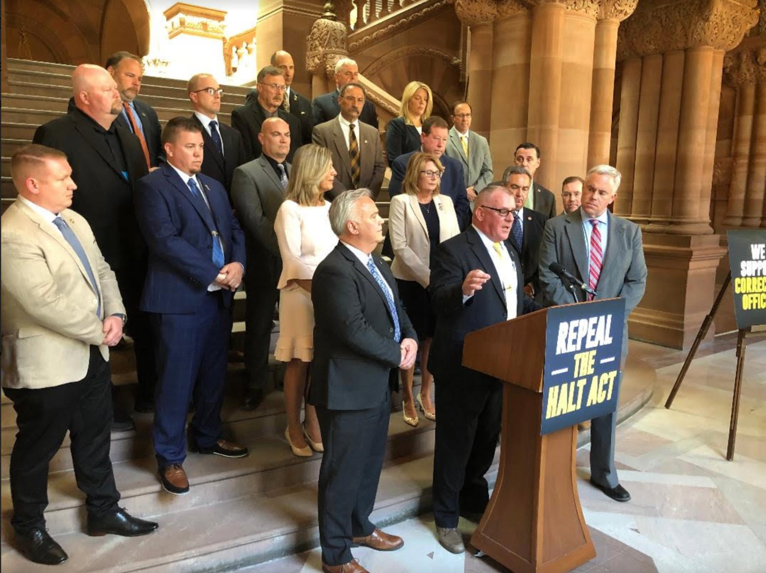 New York State Assemblyman Brian Miller, in center of back row, stands with other elected officials and state correctional officers union members to support the return of solitary confinement.