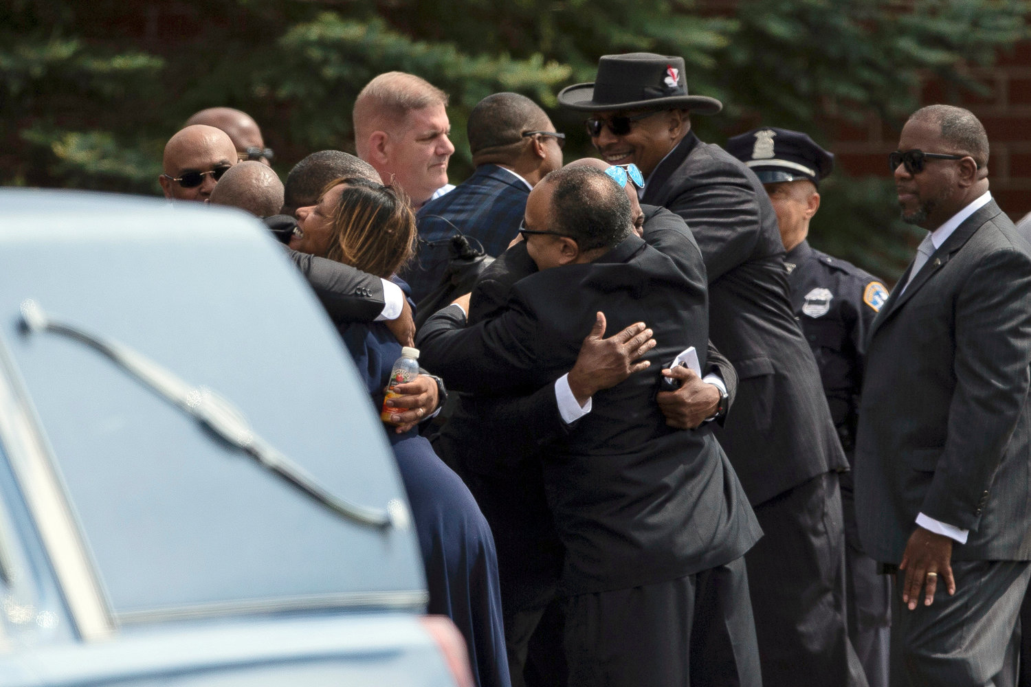 People hug before a funeral service for Aaron Salter Jr. at The Chapel at Crosspoint on Wednesday in Getzville, N.Y. Salter Jr. was killed in the Buffalo supermarket shooting on May 14.