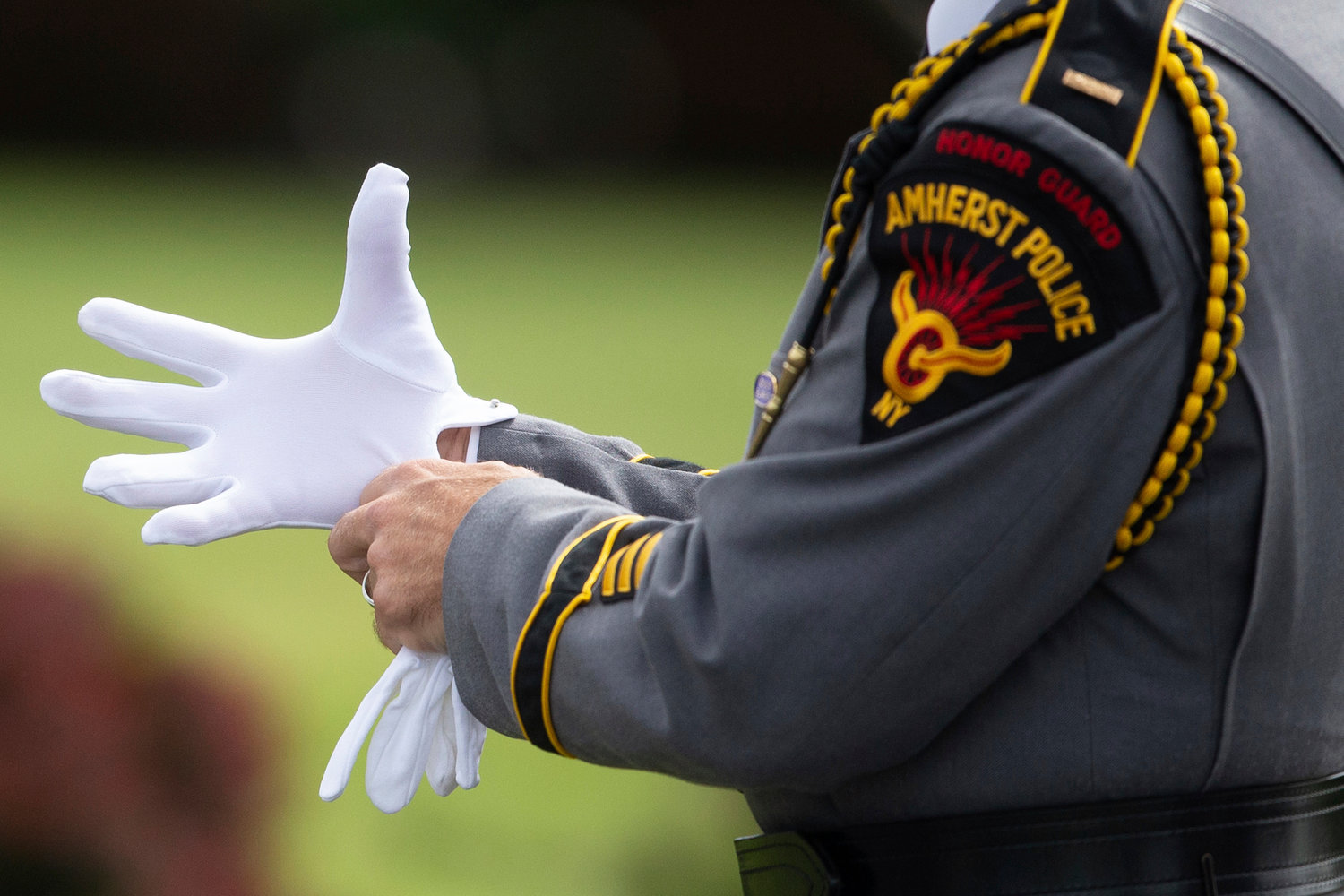 A member of the Amherst Police honor guard prepares before a funeral service for Aaron Salter Jr. at The Chapel on Wednesday, May 25, 2022, in Getzville, N.Y. Salter Jr. was killed in the Buffalo supermarket shooting on May 14. (AP Photo/Joshua Bessex)