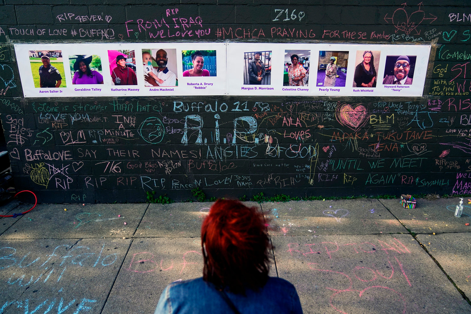 A person visits a makeshift memorial near the scene of Saturday's shooting at a supermarket, in Buffalo, Thursday, May 19, 2022. (AP Photo/Matt Rourke)