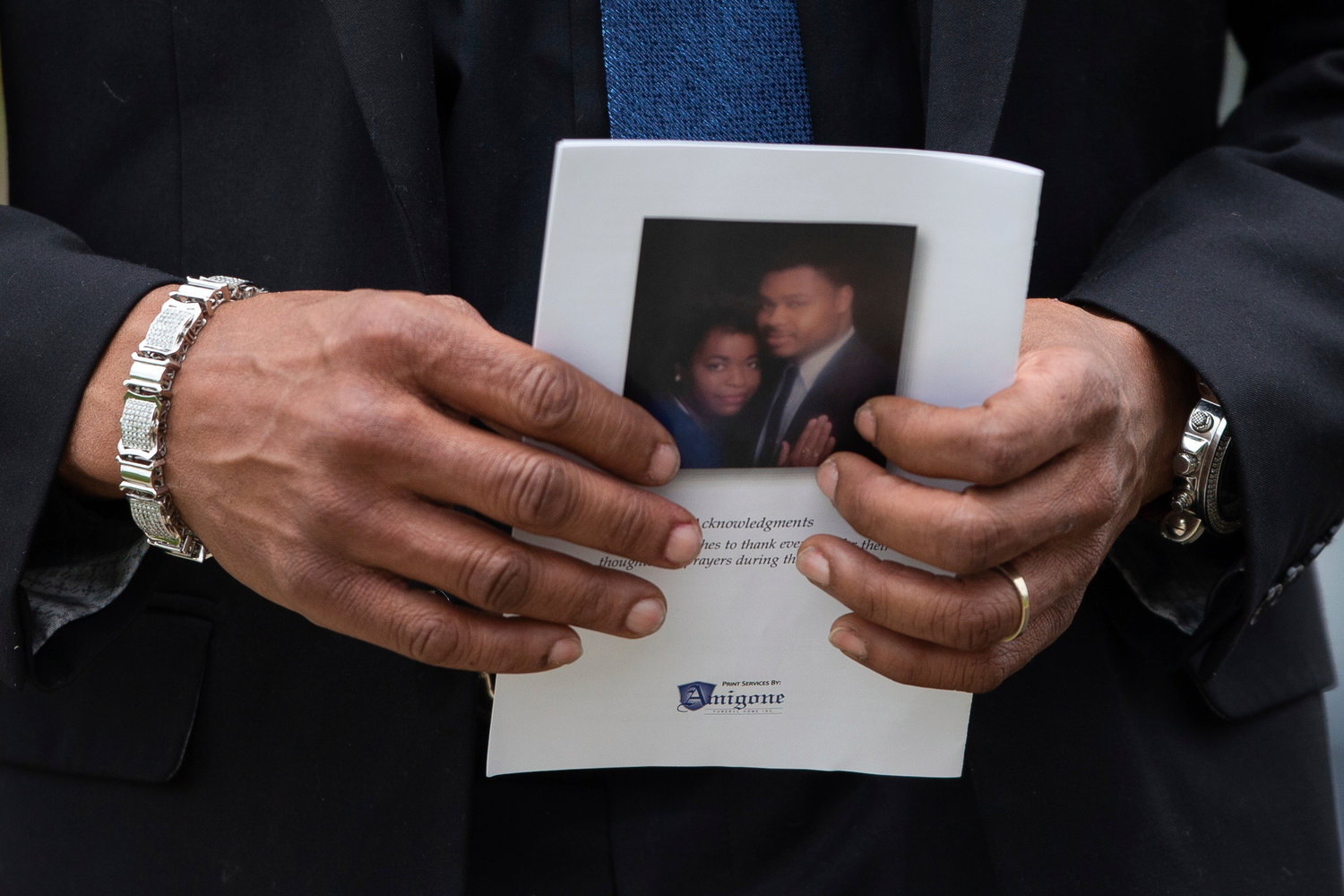 A person holds a program for the funeral service for Aaron Salter Jr. at The Chapel on Crosspoint on Wednesday, May 25, 2022, in Getzville, N.Y. Salter Jr. was killed in the Buffalo supermarket shooting on May 14. (AP Photo/Joshua Bessex)