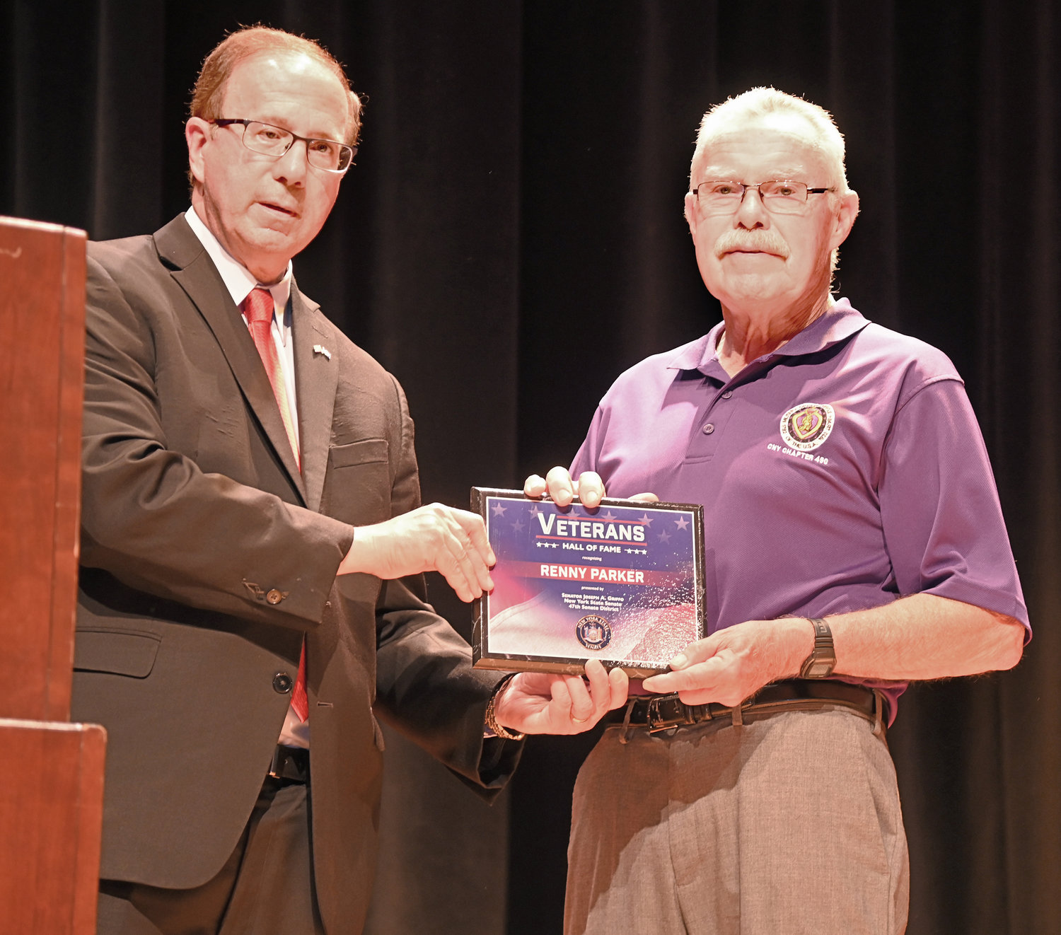 Renny Parker, right, accepts a plaque to designate his induction into the New York State Senate Veterans Hall of Fame from Sen. Joseph A. Griffo during a ceremony on Wednesday.