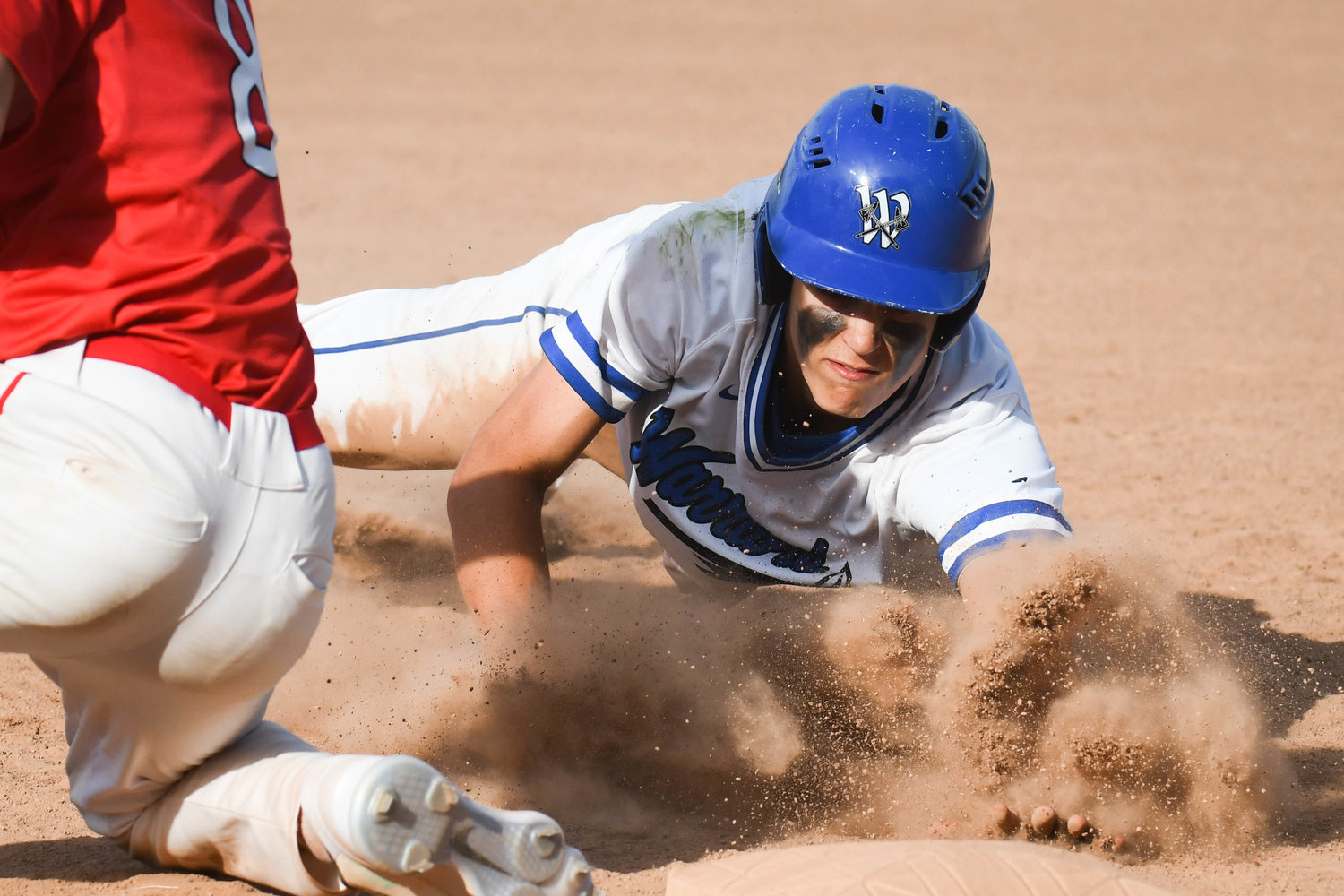 Whitesboro baserunner Ty Montrose dives safely back to first base during a pickoff attempt during the game against Jamesville-Dewitt on Thursday. The Warriors won 4-2 to advance to the Section III Class A semifinals.