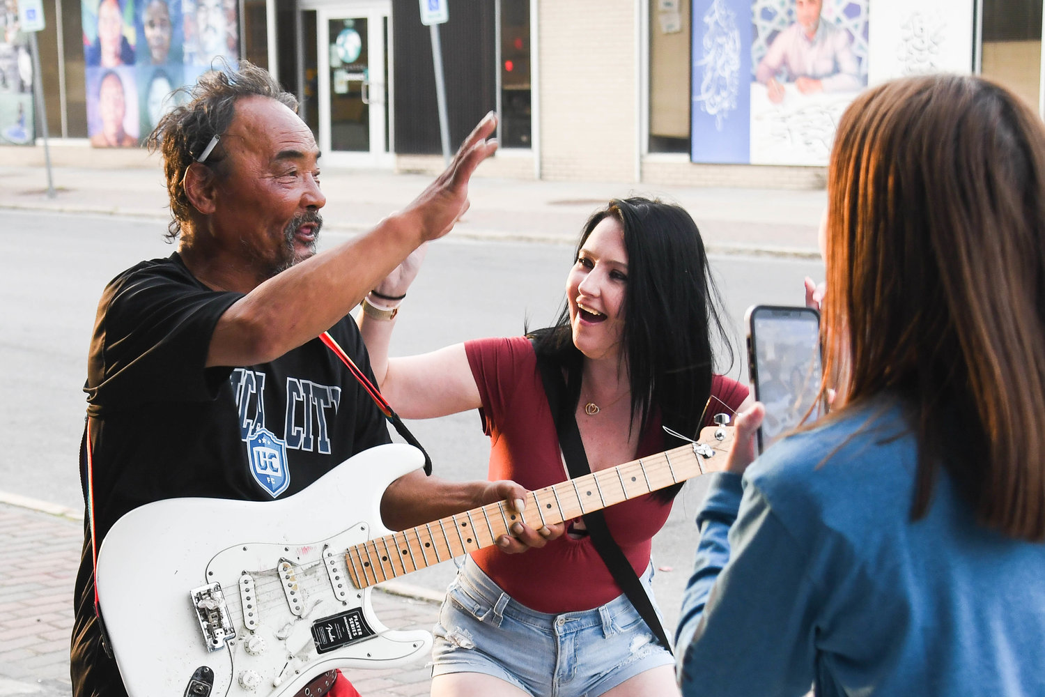 Rainbow Young plays his guitar for guests outside of The Hub Eatery on Thursday in Utica. A going away party was thrown for him after announcing that he is leaving for New York City at the end of June.