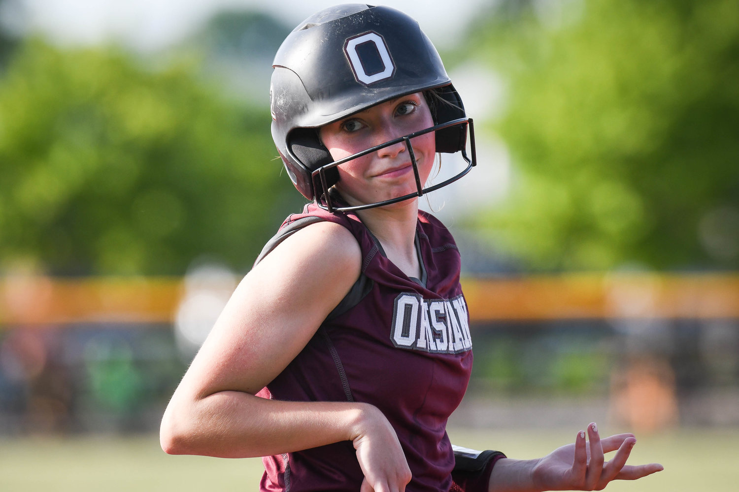 Oriskany player Juliet Tagaliaferri shrugs at her coach after making it safely to third base during the Section III Class D final against Poland on Tuesday at Carrier Park in Syracuse. Oriskany won 5-4.
