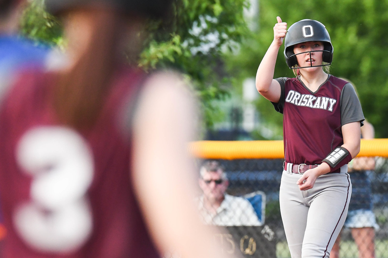 Oriskany catcher Kaelyn Buehler gives a thumbs up to a teammate from first base during the Section III Class D final against Poland on Tuesday at Carrier Park in Syracuse. Oriskany won 5-4.