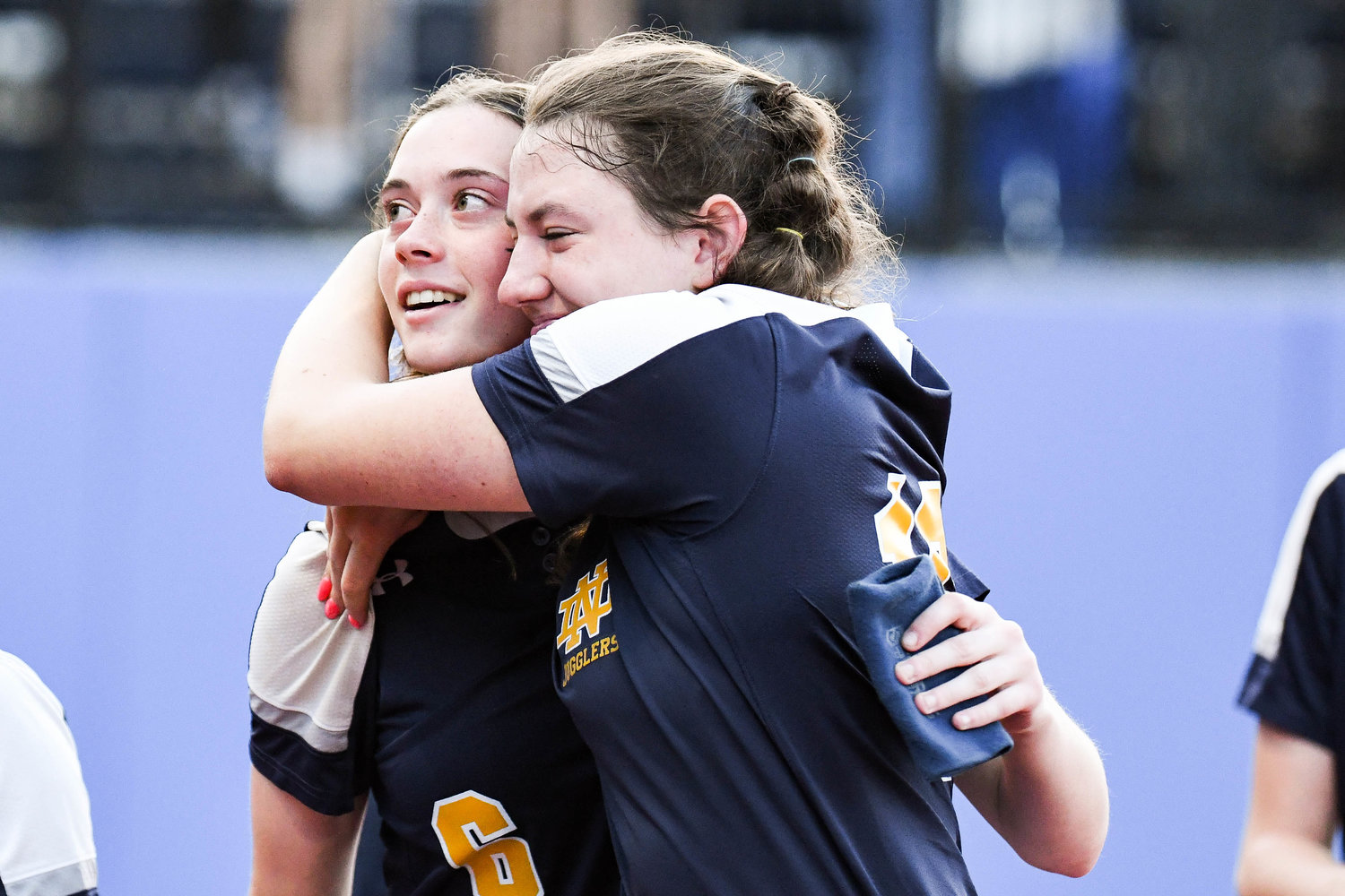 Utica-Notre Dame softball players Maggie Trinkaus, left, and Ava Hayes hug after losing 7-3 in the Section III Class C final to Sandy Creek on Thursday at Onondaga Community College.