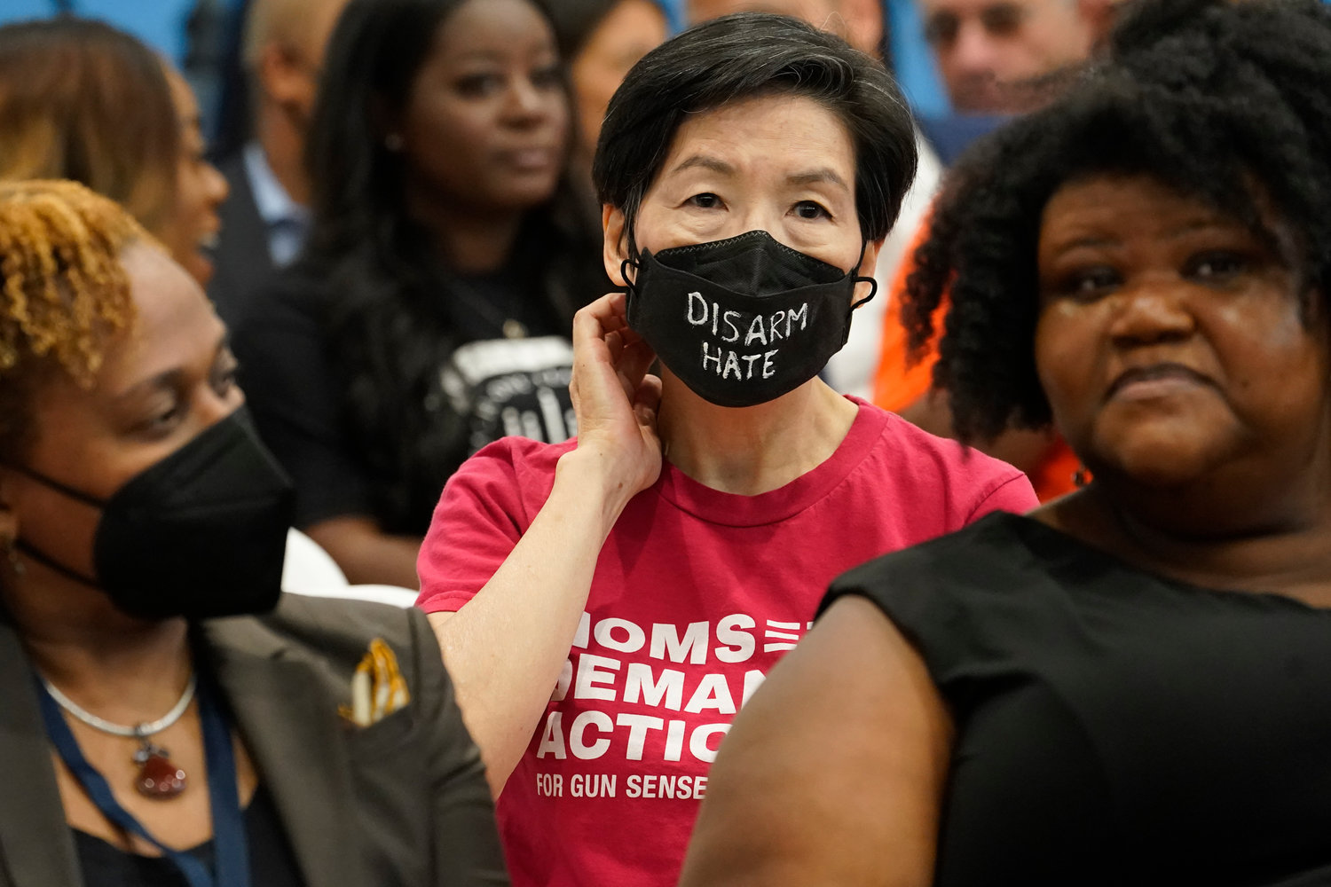 A member of Moms Demand Action wears a face mask denouncing hate during a ceremony where Gov. Kathy Hochul signed a package of bills to strengthen gun laws, Monday, June 6, 2022, in New York. (AP Photo/Mary Altaffer)