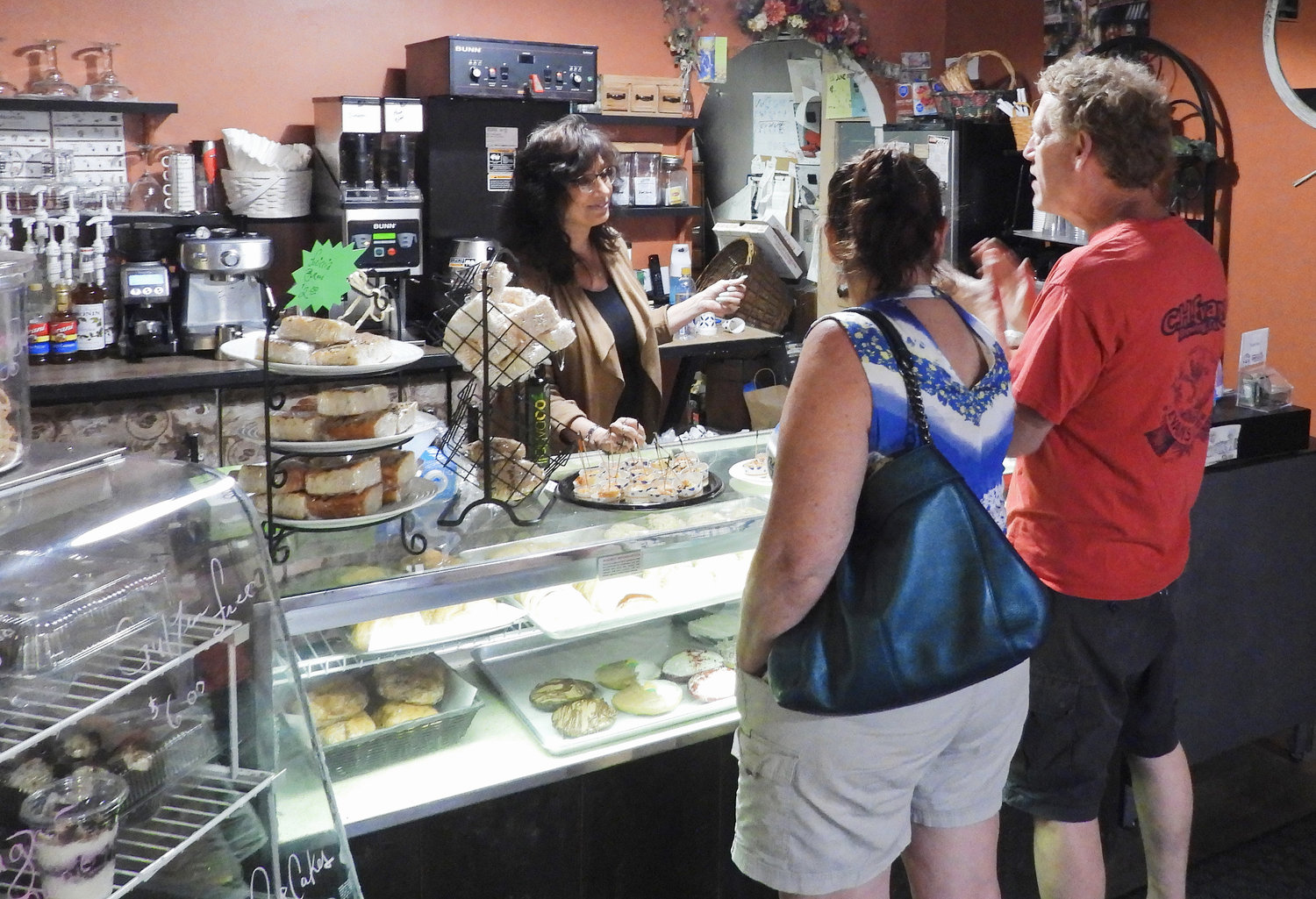 Bella Vita Cafe Owner Lori Seef talks with visitors and customers at the grand opening of the Cafe's bakery addition.