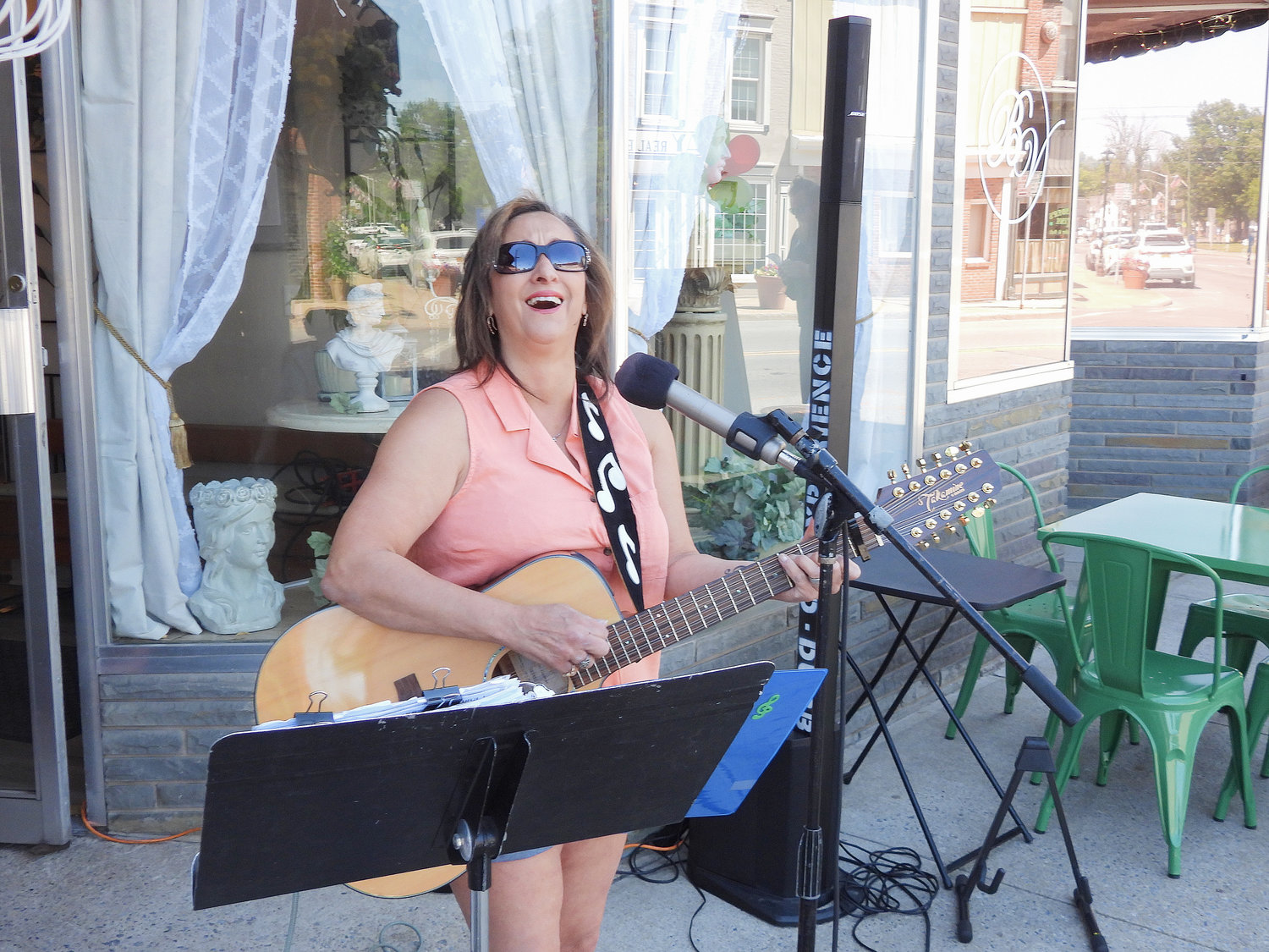 Local musician Ann Wieder plays outside Bella Vita Cafe, singing a variety of songs to the delight of visitors and passerbys.