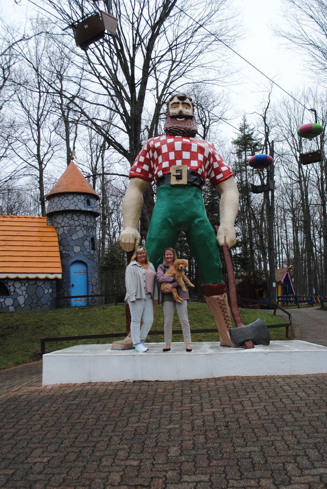 From left, Kelly Greene and Katie Wojdyla with the 18-foot Paul Bunyan that welcomes visitors into the Enchanted Forest Water Safari in Old Forge.