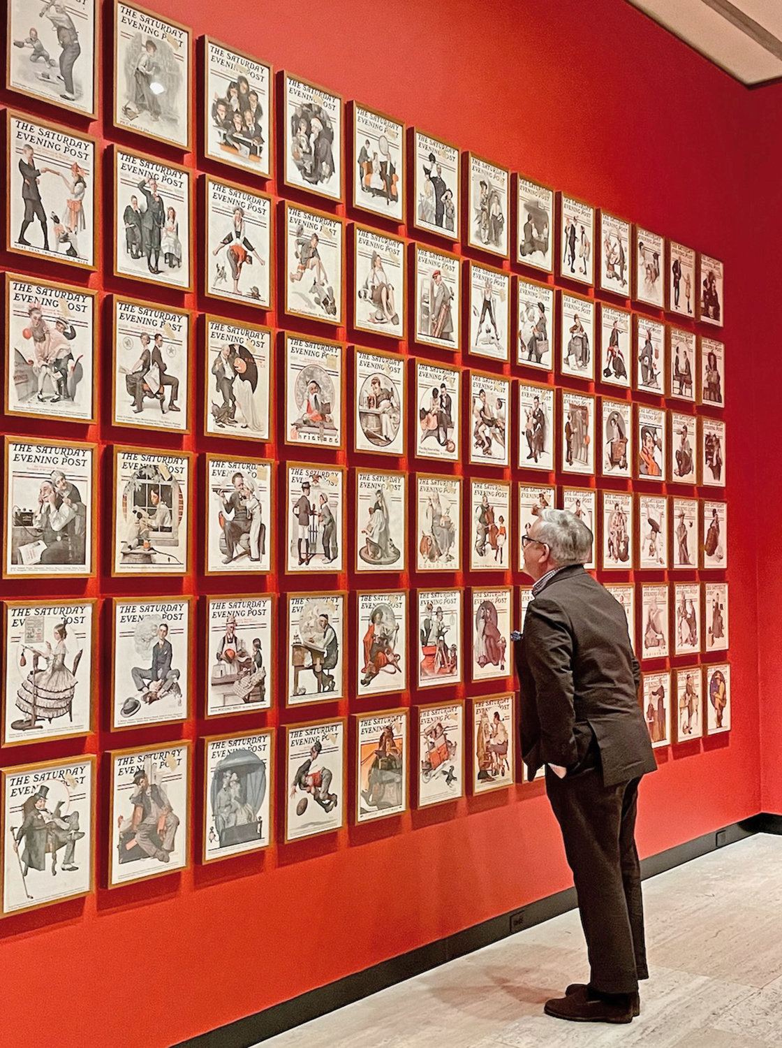 Munson-Williams-Proctor Arts Institute Chief Curator Stephen Harrison views the covers of the Saturday Evening Post featuring illustrations by American culture artist Norman Rockwell as part of the museum's newest exhibit, which officially opens to the public on Saturday.