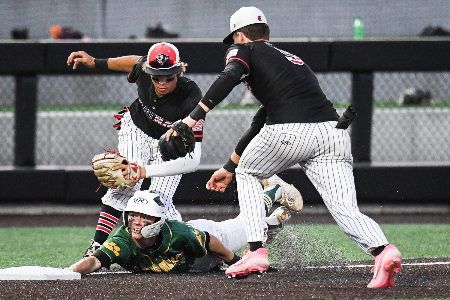 Adirondack player Kreedon Rogers (2) successfully avoids a tag at third base during the state Class C semifinal game against Chatham on Friday at Binghamton University.