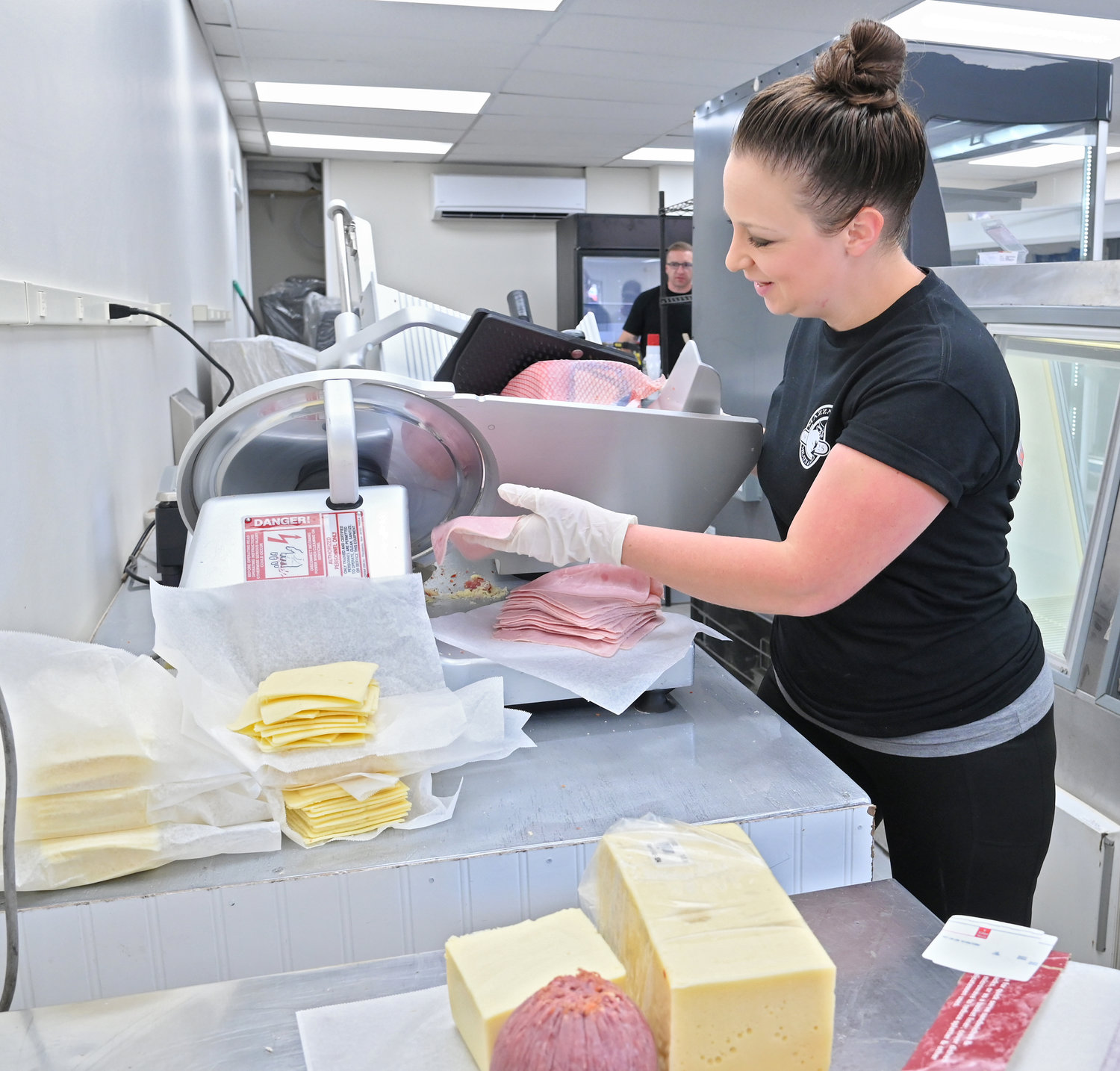 Mazzaferro’s Meats & Deli manager Sabrina Davis slices up ham at the Railroad Street location on Friday. The satellite store will be used for business until a new building is put up at their old Ridge Mills Road location.