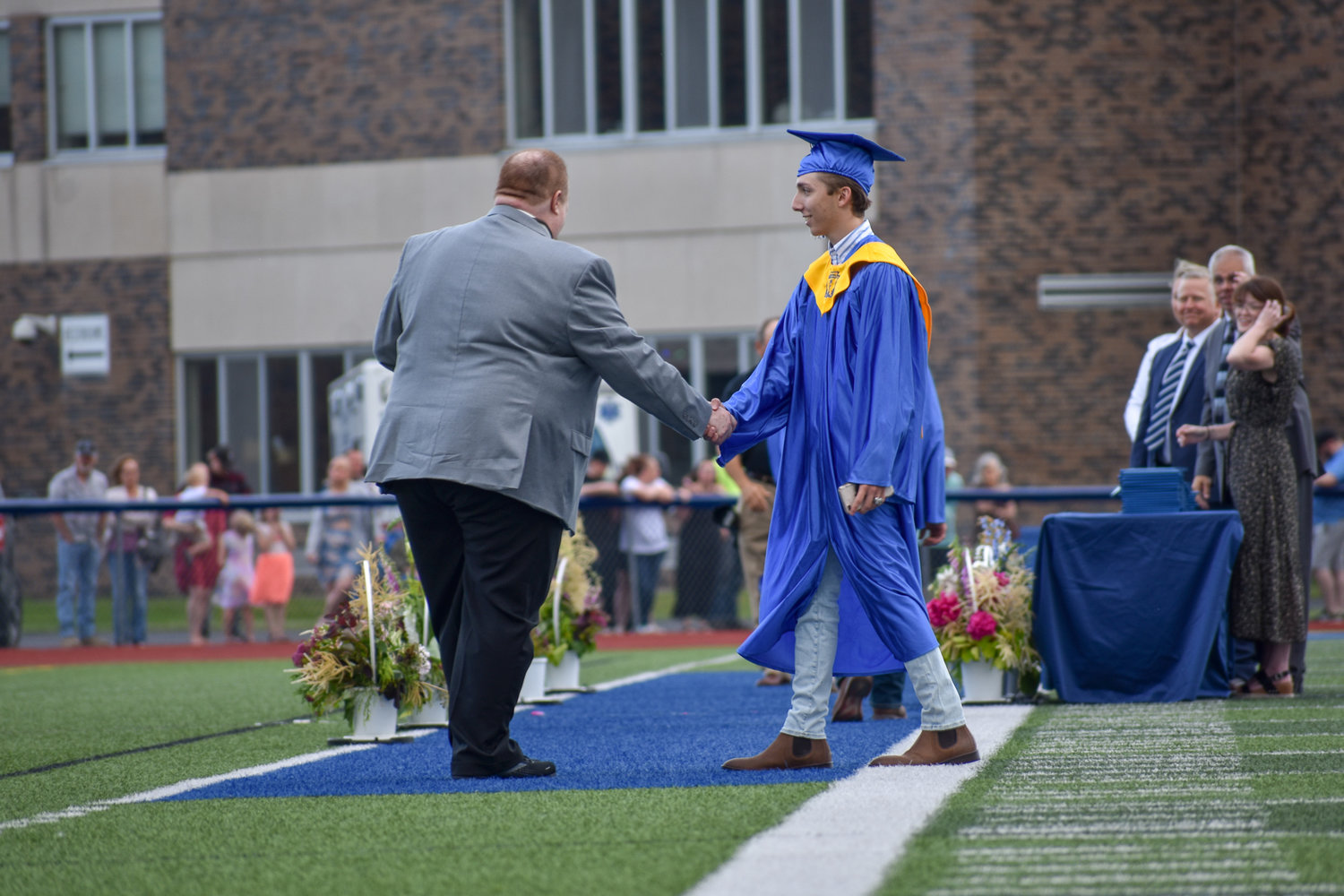 A Camden senior prepares to walk across the field and receive his high school diploma.