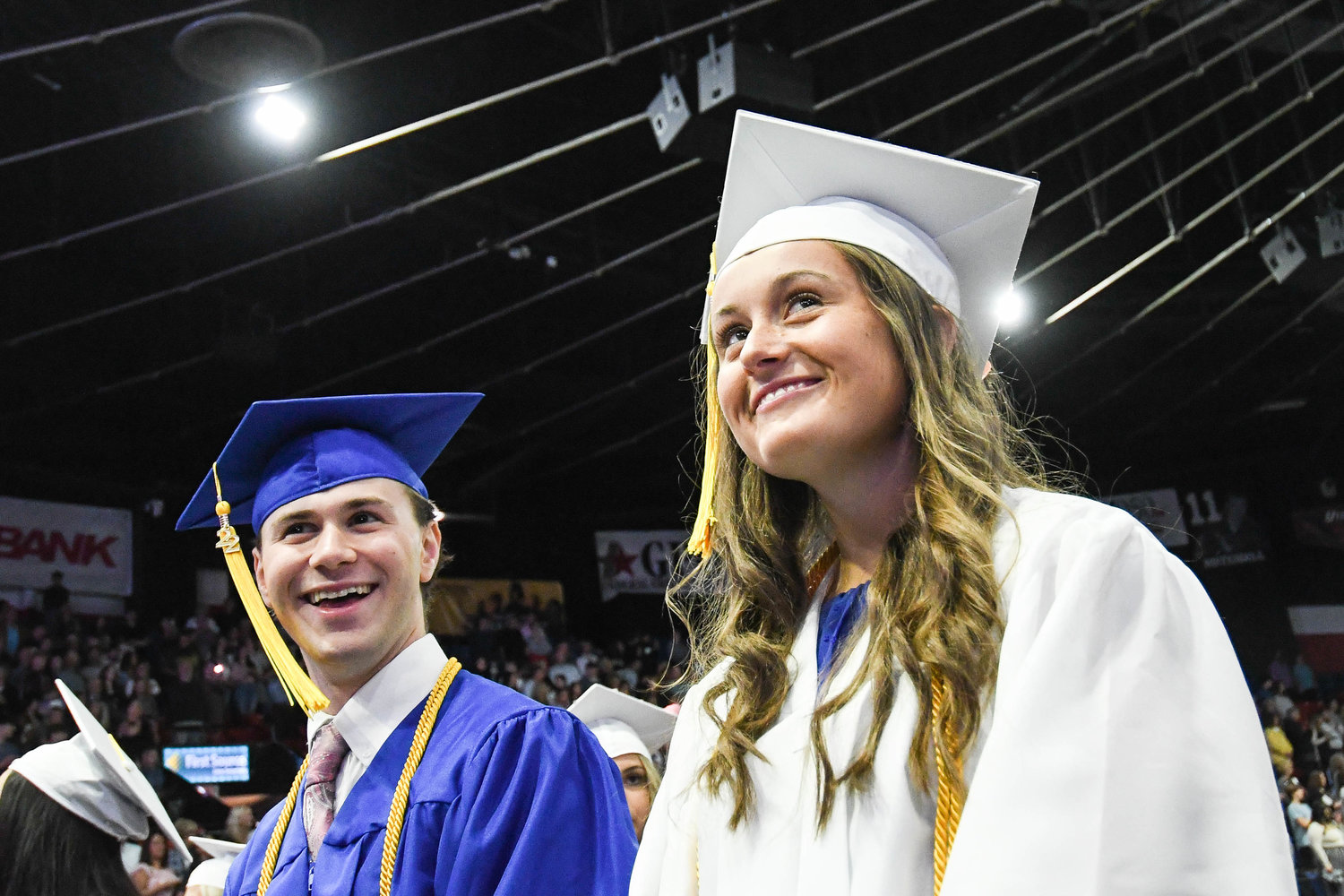 Graduates AJ DiSpirito, left, and Ryann DePerno look around at the crowd during Whitesboro High School’s 87th annual commencement ceremony for the class of 2022 on Saturday at the Adirondack Bank Center.