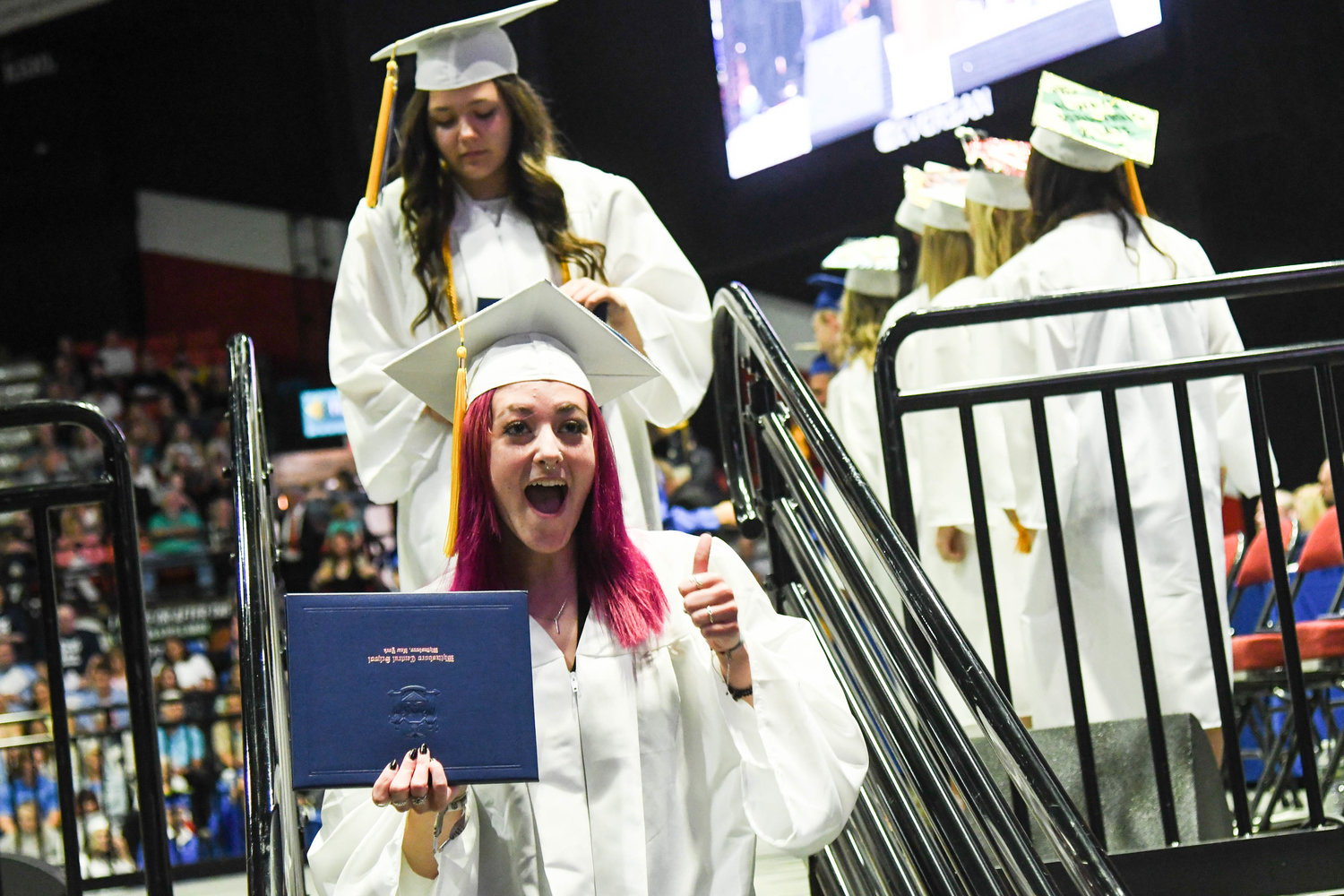 Ava Block gives a thumbs up to the crowd after receiving her diploma during Whitesboro High School's 87th annual commencement ceremony for the class of 2022 on Saturday at the Adirondack Bank Center at the Utica Memorial Auditorium.