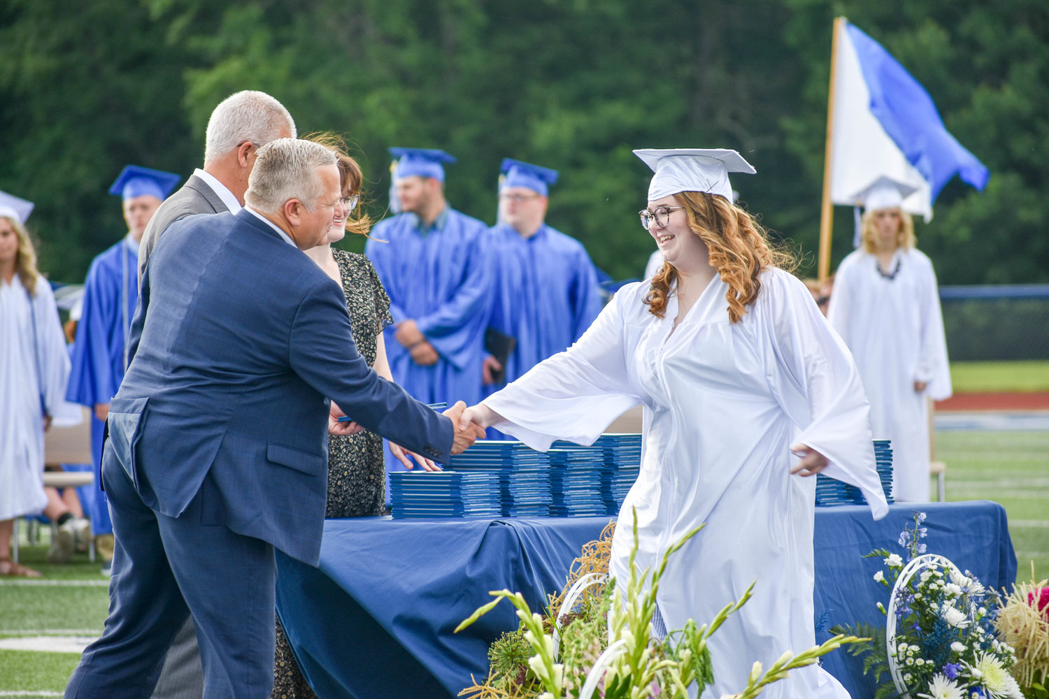 A Camden Class of 2022 graduate shakes hands and receives her diploma.
