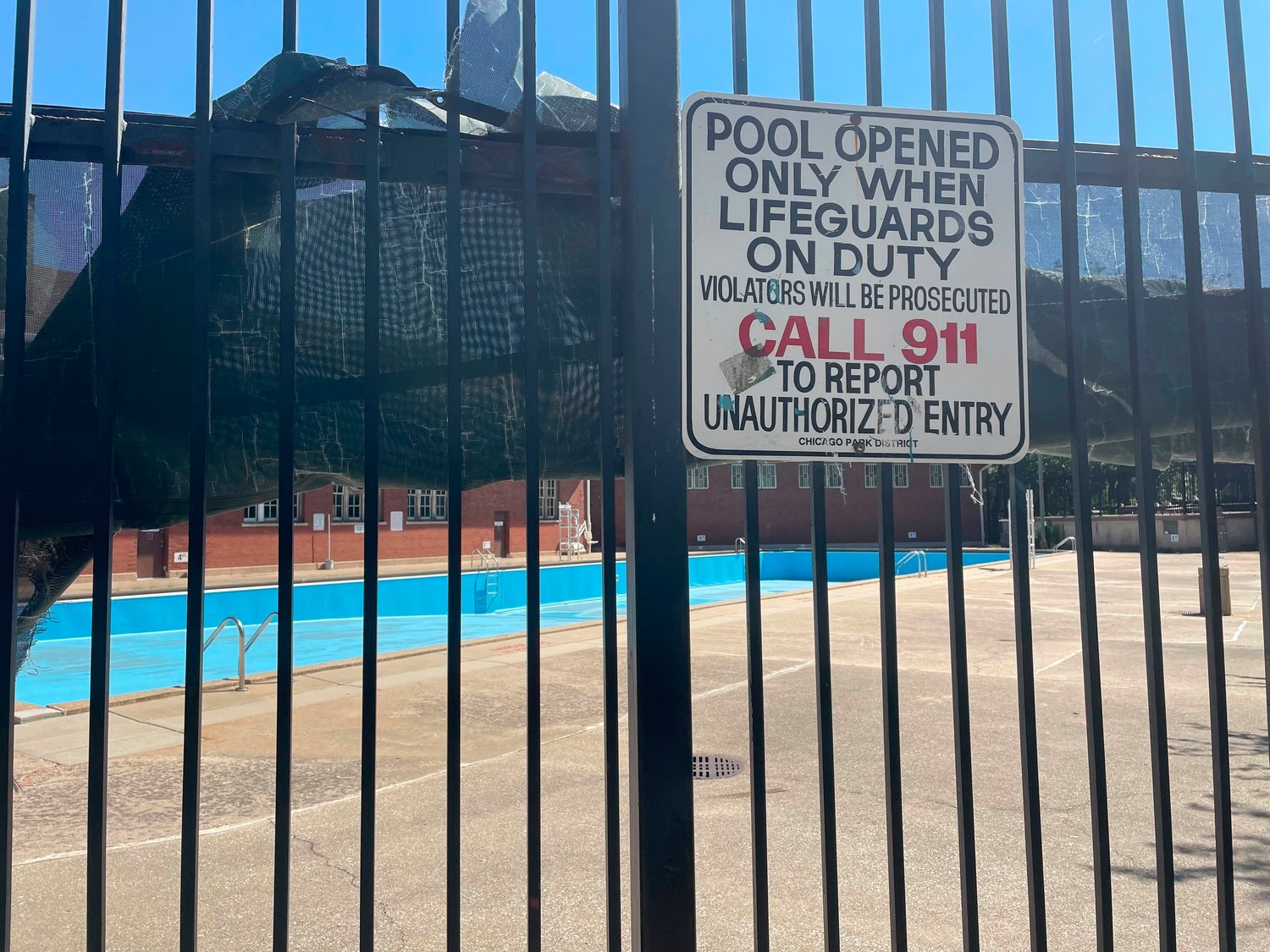 The empty pool at the Hamlin Park Pool remains closed to swimmers in Chicago, Thursday, June 16, 2022. Chicago's public pools will remain closed until July 5, 2022, according to park superintendent and CEO Rosa Escare√±o. The city, like the rest of the U.S., is experiencing a critical shortage of lifeguards and is offering $600 retention bonuses to attract new applicants. (AP Photo/Claire Savage)