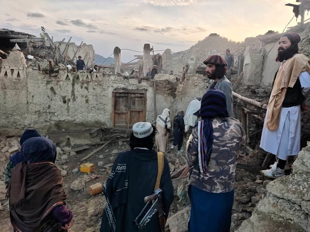 In this photo released by a state-run news agency Bakhtar, Afghans look at destruction caused by an earthquake in the province of Paktika, eastern Afghanistan, Wednesday, June 22, 2022. (Bakhtar News Agency via AP)