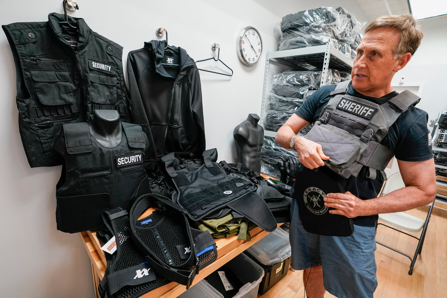 Brad Pedell, a founder of 221B Tactical, demonstrates how a Level 3 plate and plate carrier are used during an interview with The Associated Press recently.