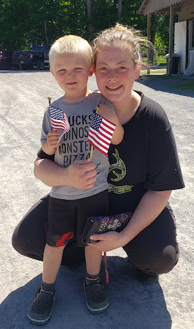In honor of Flag Day, Desiree Rogers and her son, Leo, received flags for being among the first 100 customers at the Lyons Falls Farmers Market on Tuesday, June 14.
