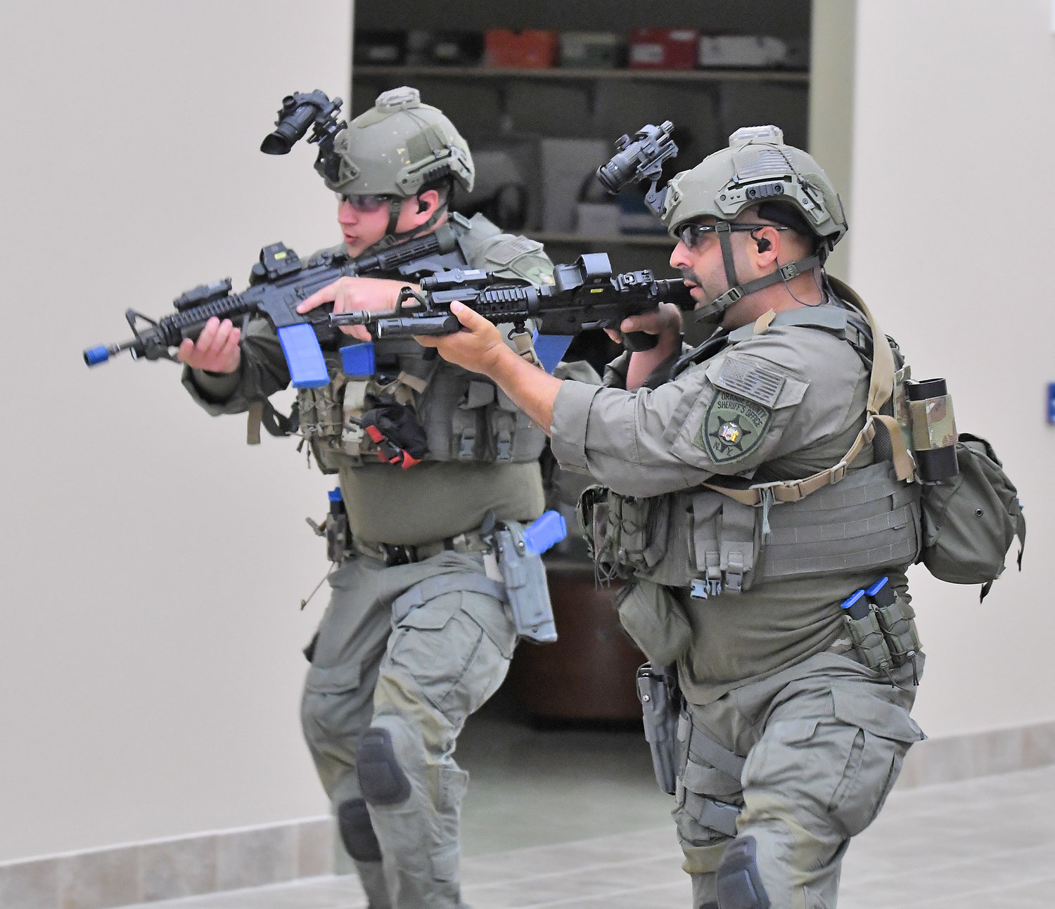 SWAT team members from the Orange County Sheriff's Office proceed through a simulated mall setting to find an active shooter during a scenario at the New York State Preparedness Training Center in Whitestown.