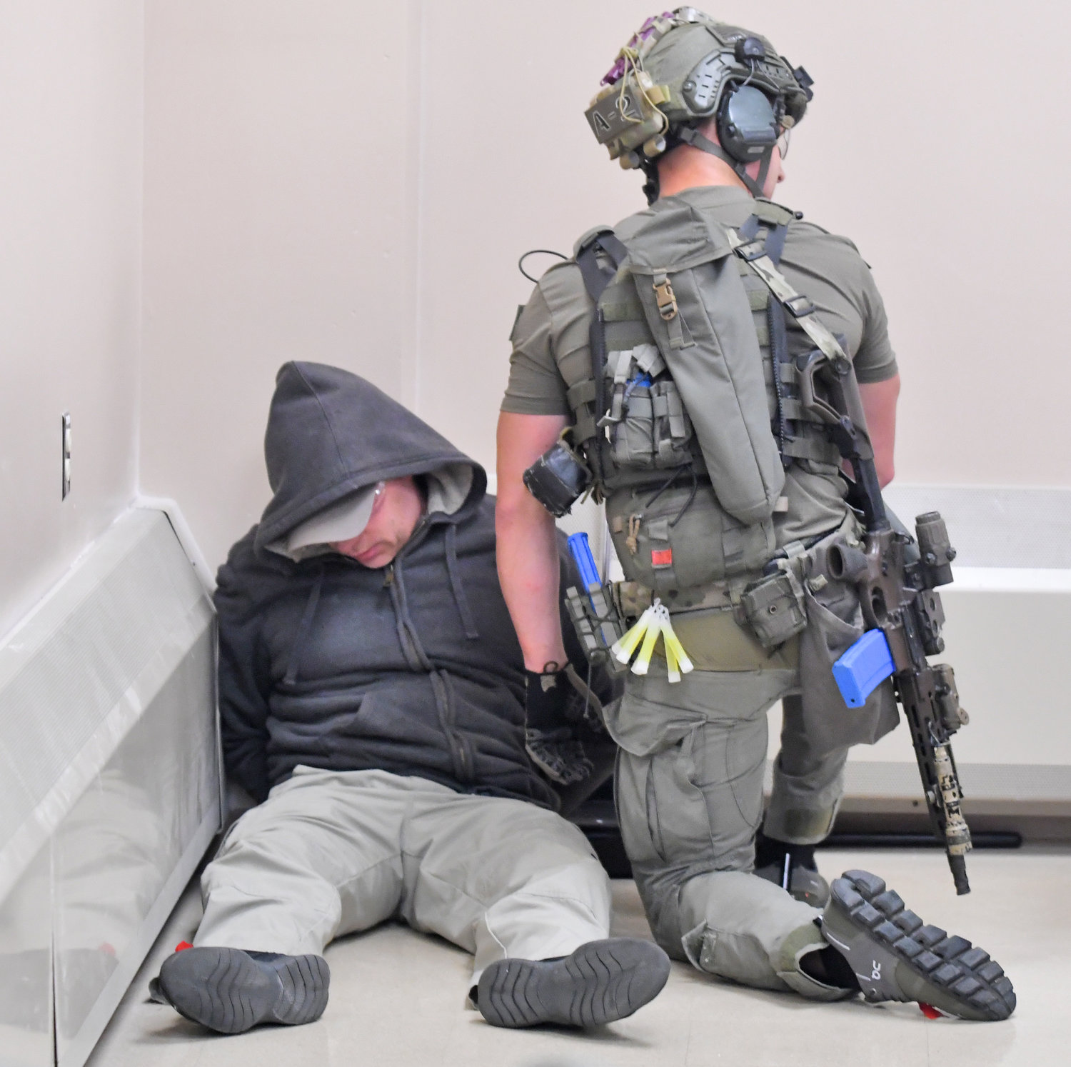 A member of the Erie County Sheriff's SWAT team keeps watch over a shooting suspect during a training session at the New York State Preparedness Training Center in Whitestown.