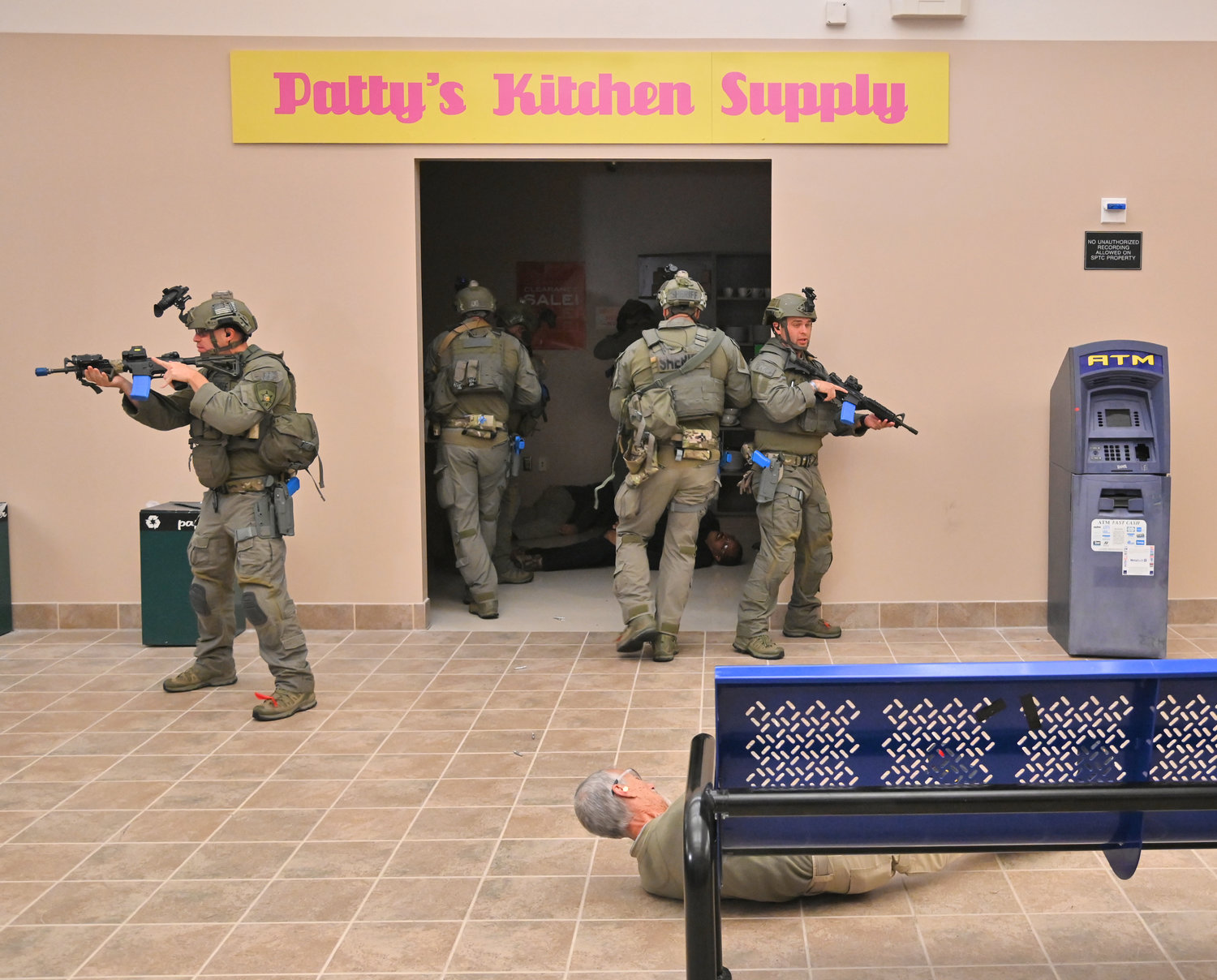 Members of the Orange County Sheriff's SWAT team take up position in a fake mall setting as part of an active shooter training scenario at the New York State Preparedness Training Center in Whitestown.