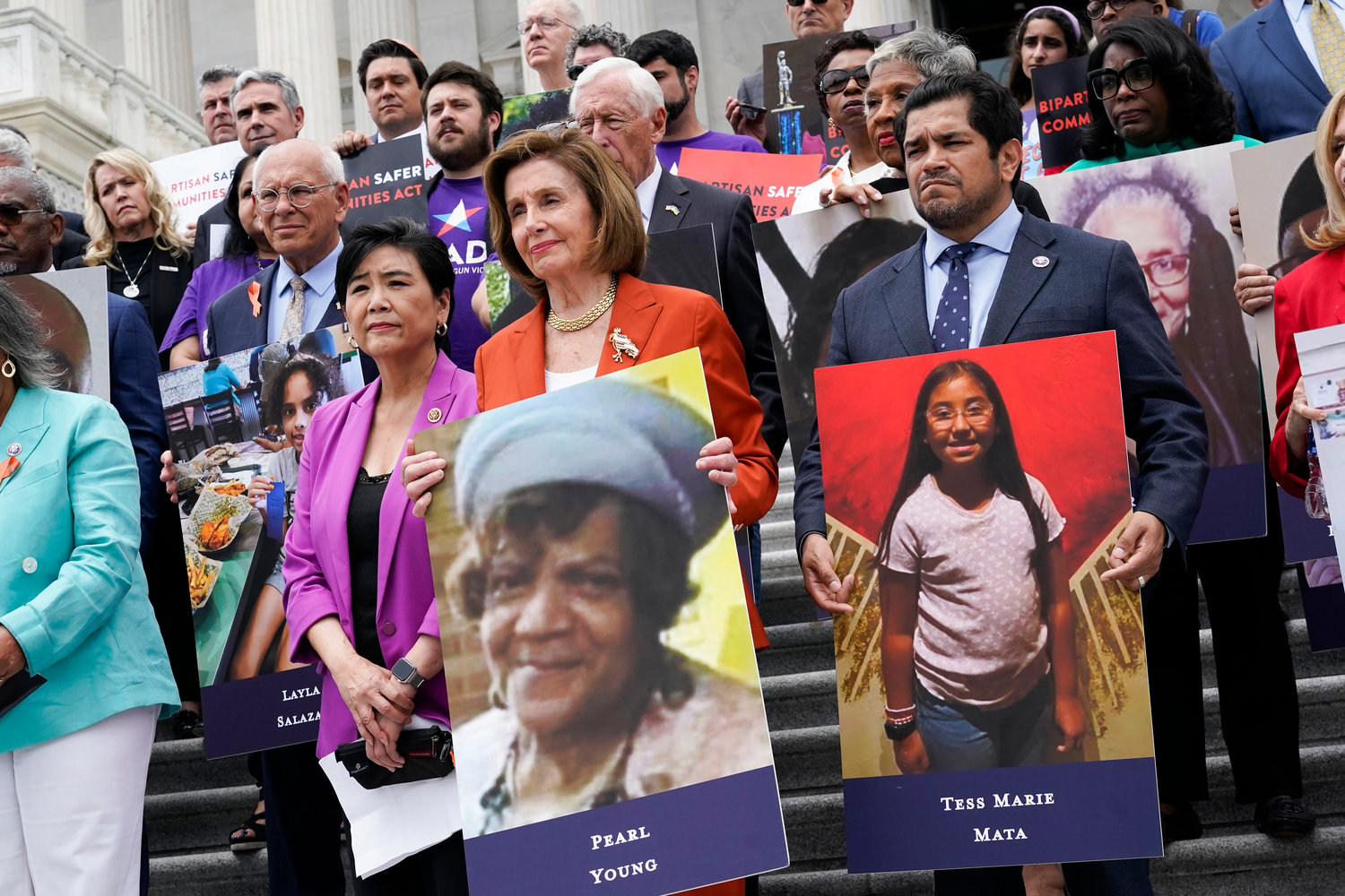 House Speaker Nancy Pelosi of Calif., and other lawmakers, talk about the gun violence bill at the Capitol in Washington Friday. At left is Rep. Judy Chu, D-Calif., and at right is Rep. Jimmy Gomez, D-Calif.