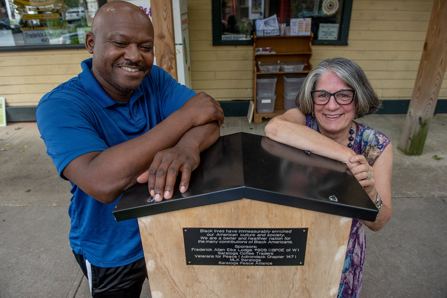 Frederick Allen Lodge Exalted Ruler Kendall Hicks and Associate member and Saratoga resident Linda LeTendre help display the first Little Free Library specializing in Black culture and history, outside Frederick Allen Lodge on Beekman Street in Saratoga Springs.