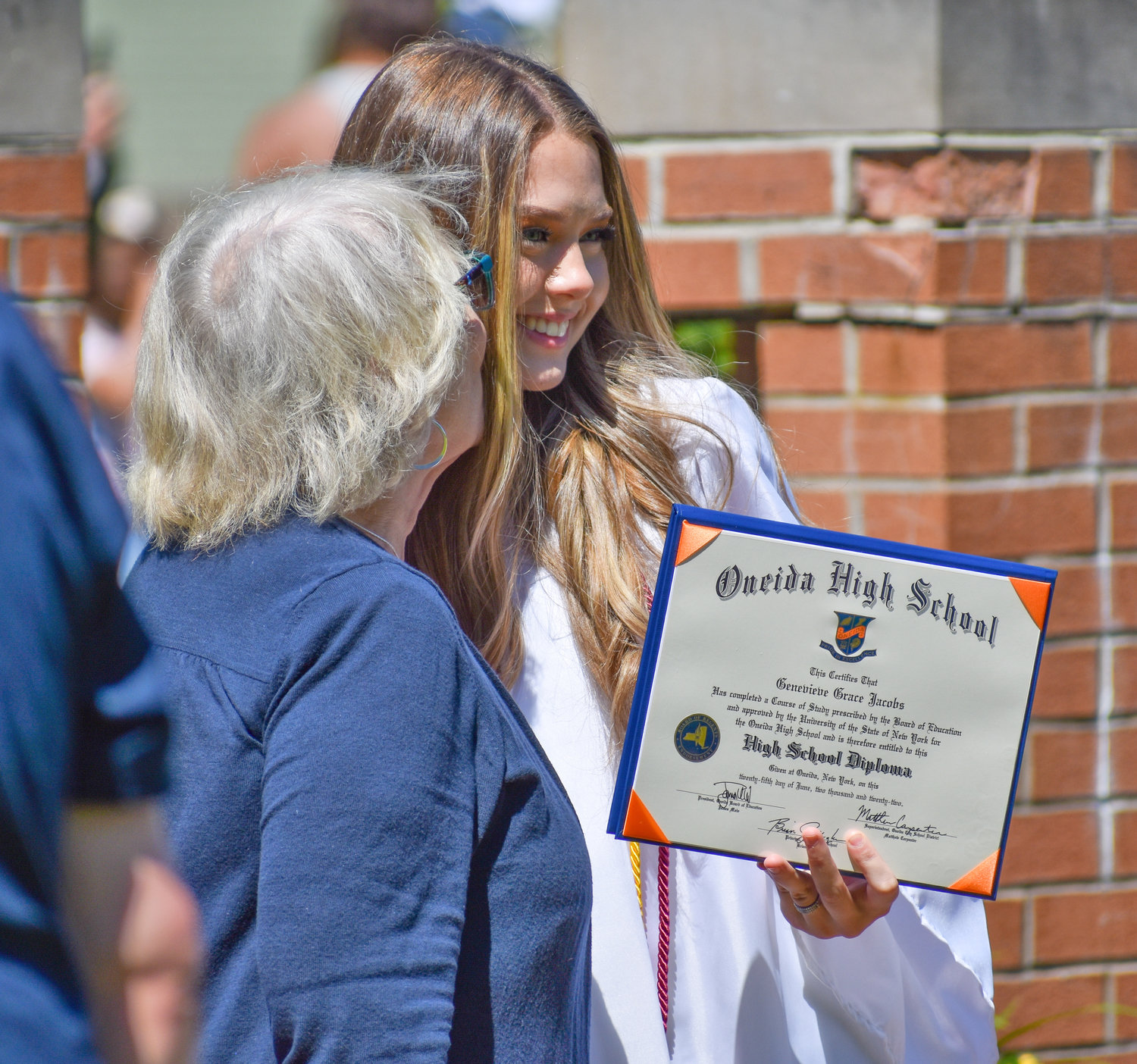 Oneida graduate Genevieve Grace Jacobs receives a kiss on the cheek from proud grandma Marcia Rafte.