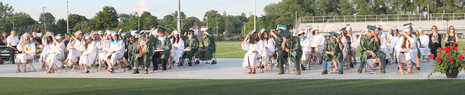 MOVING TASSELS — Signifying their change in status from students to graduates, members of the Adirondack High School Class of 2022 move their tassels from left to right on their mortarboards.