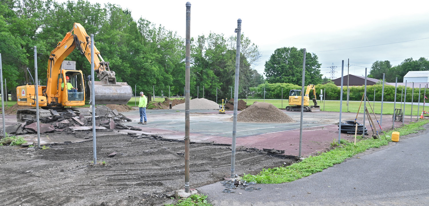 Town of Lee park work on replacing the tennis courts Thursday afternoon.