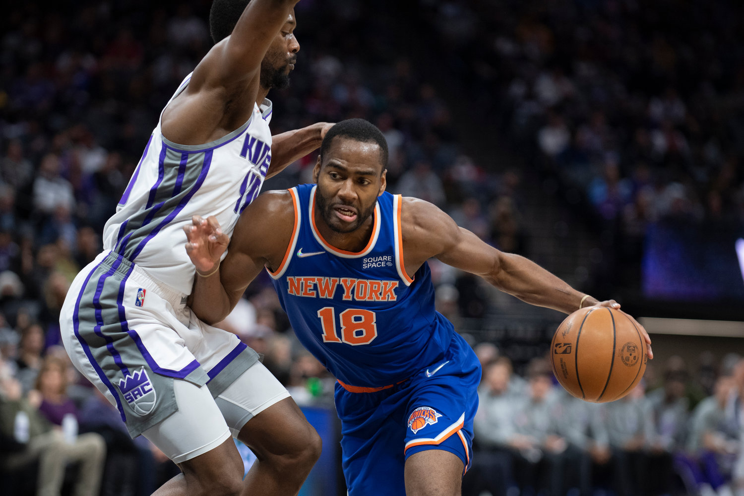 New York Knicks guard Alec Burks, right, is defended by Sacramento Kings forward Harrison Barnes in the first quarter in Sacramento, Calif., on March 7. The Knicks are trading Burks Nerlens Noel to the Detroit Pistons, a person with knowledge of the details said Tuesday, moves that free up nearly $20 million more for free agency.