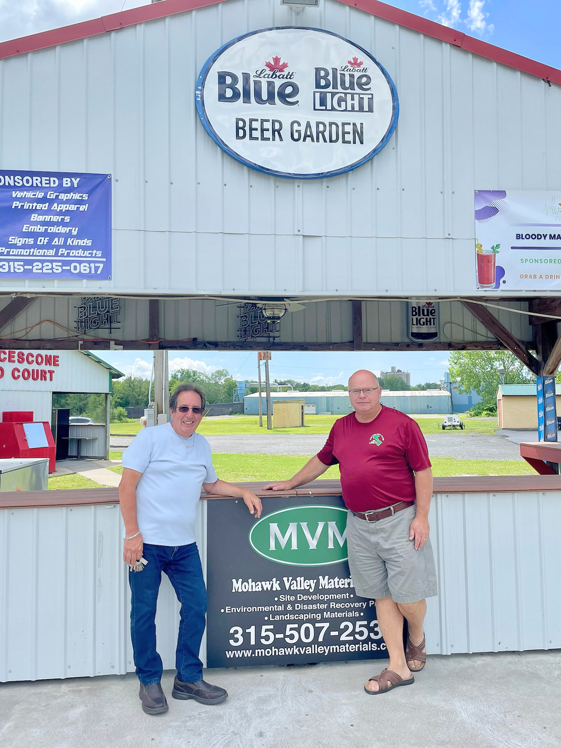 Rome's World Series of Bocce co-organizers Michael Ferlo, left, and David Smith stand in front of the "Beer Garden" that will serve beverages to thirsty bocce players during the upcoming four-day tournament July 14-17 at the Toccolana Club on East Dominick Street.