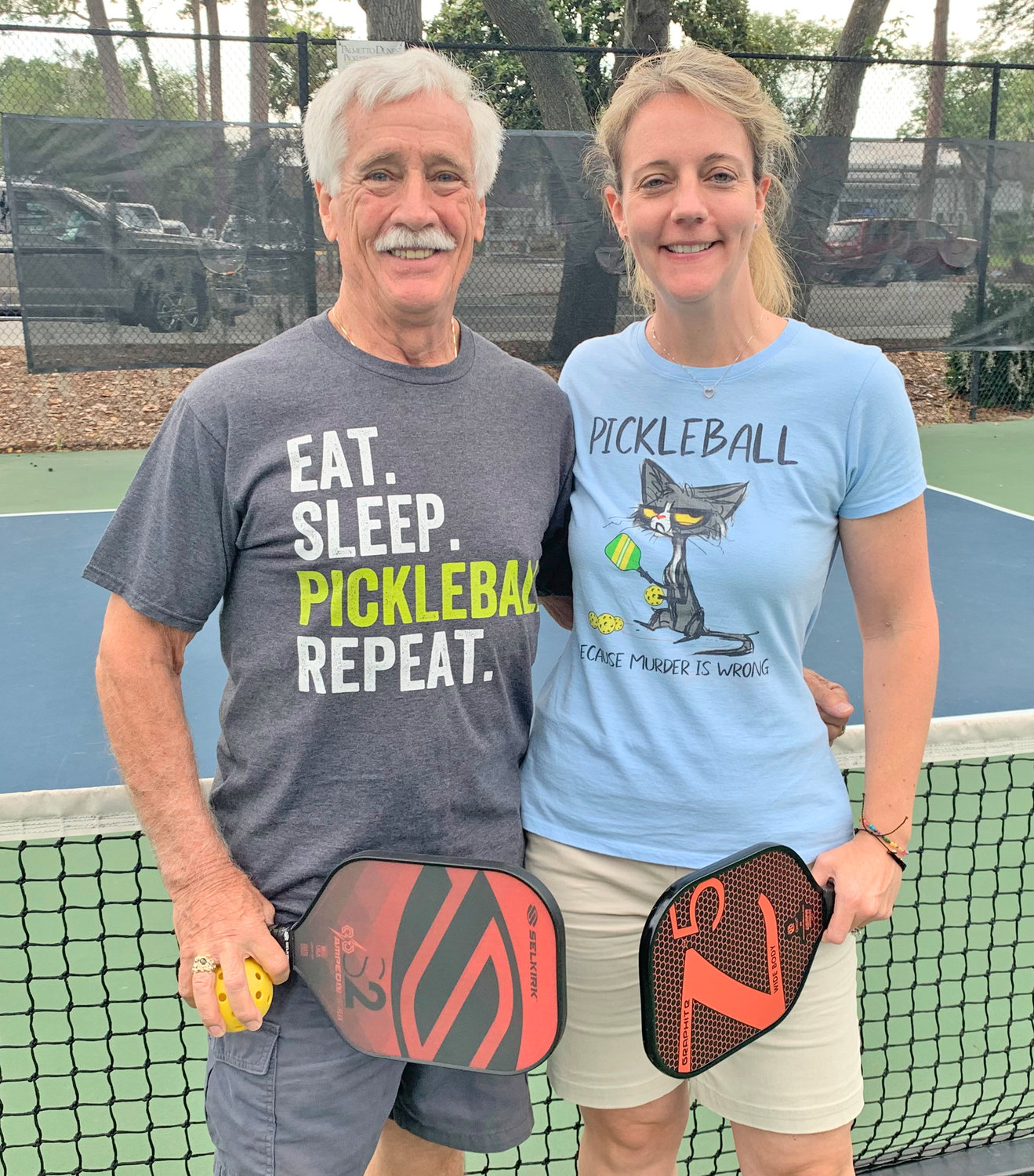 Grandmaster Clifford Crandall Jr. and his wife Amanda Crandall pose for a picture in the pickleball court during the Pickleball Nationals in South Carolina.